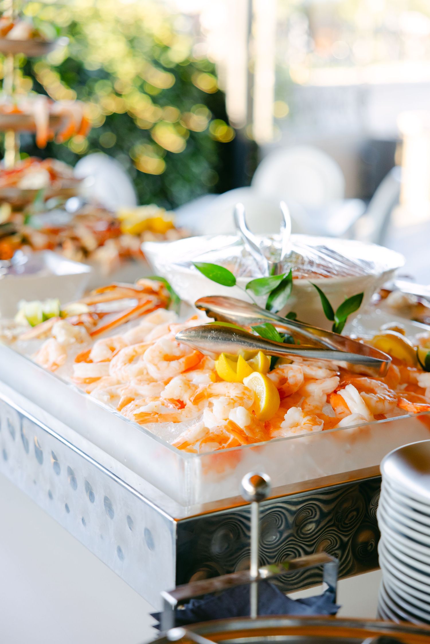 Elegant seafood display featuring fresh crab legs and garnishes on a silver serving tray.