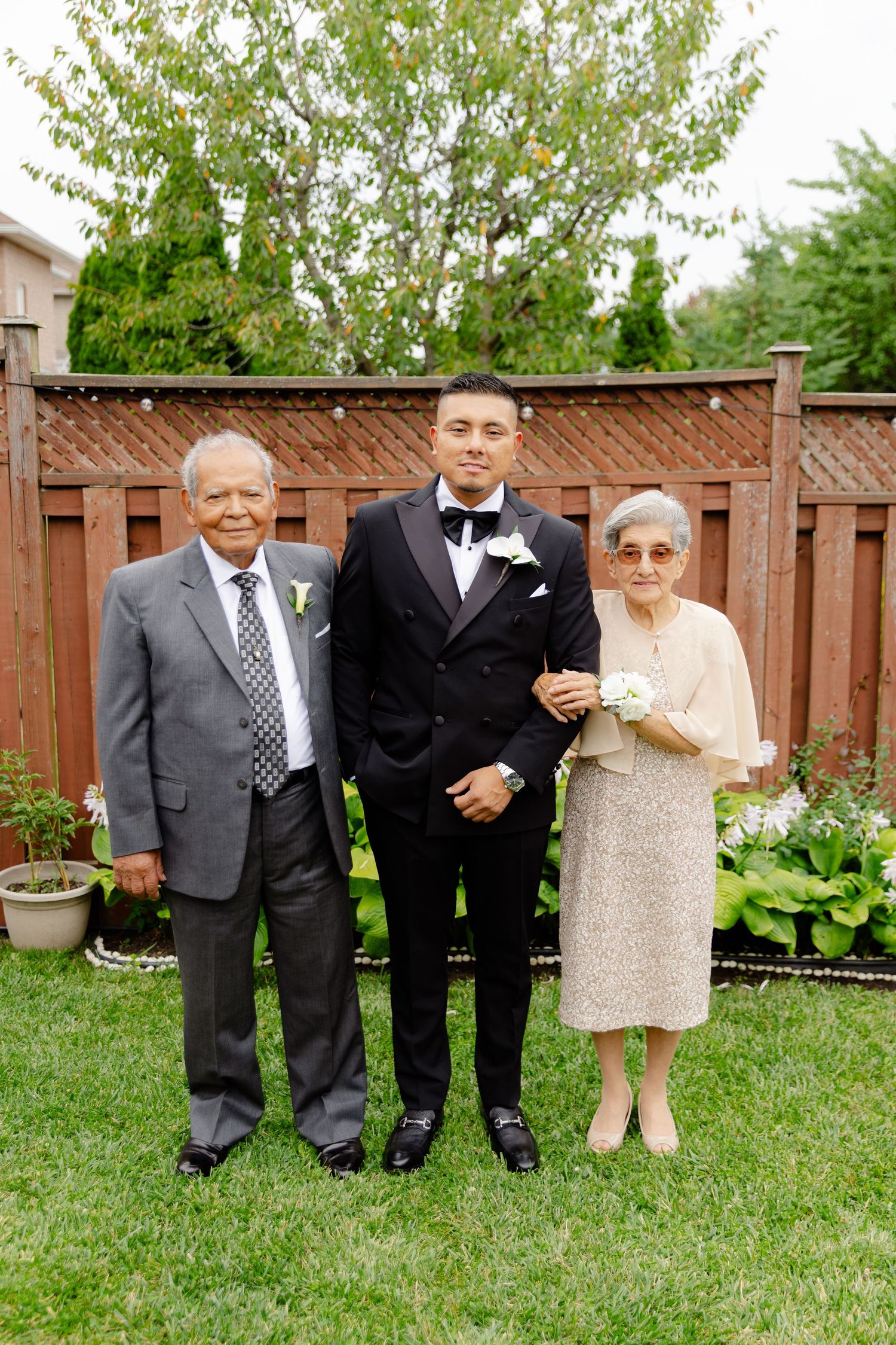 A touching multi-frame sequence showing a couple in formal attire posing together in a backyard garden.