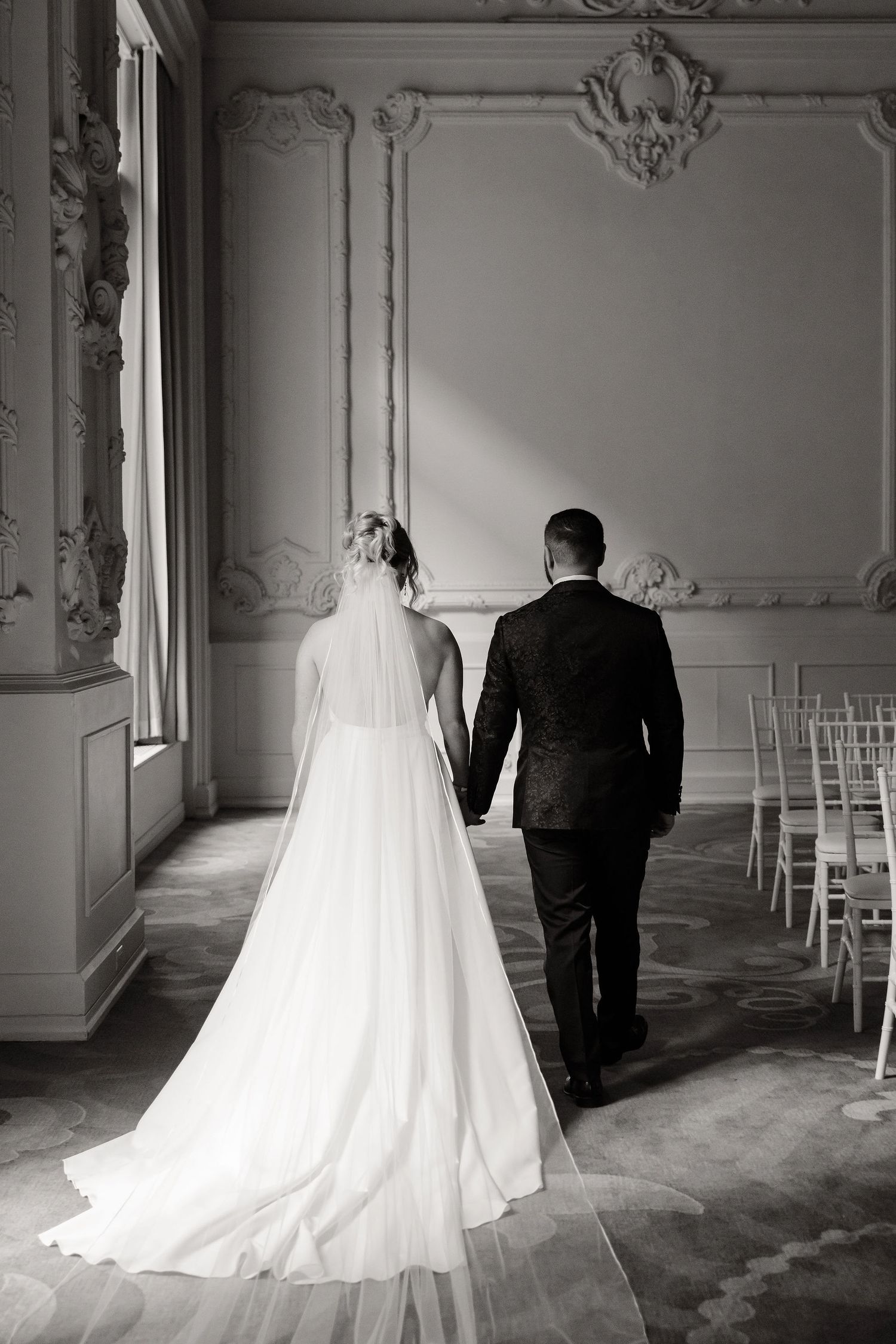 Black and white wedding photos showing dramatic silhouettes against ornate wall panels.