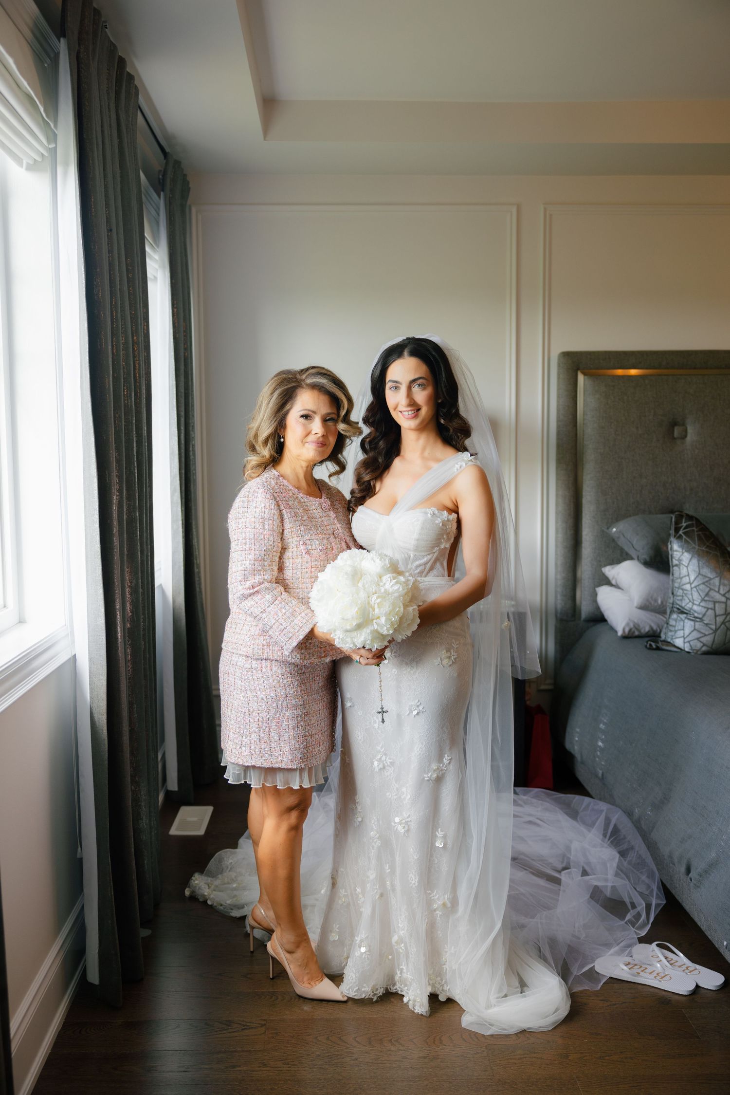Wedding preparation scene in a bright room with elegant curtains.