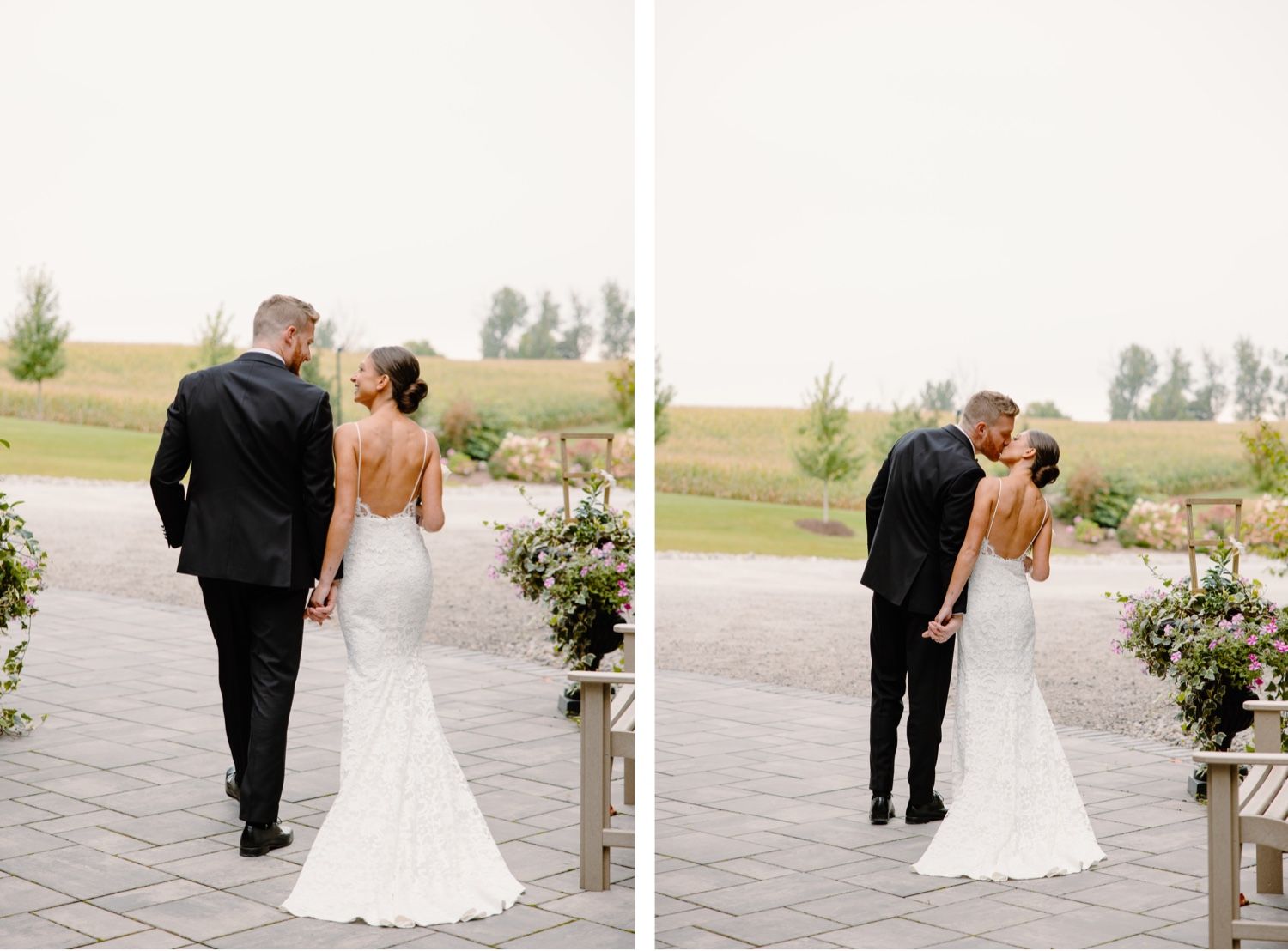 A wedding couple walking away and sharing a tender moment on a paved path.