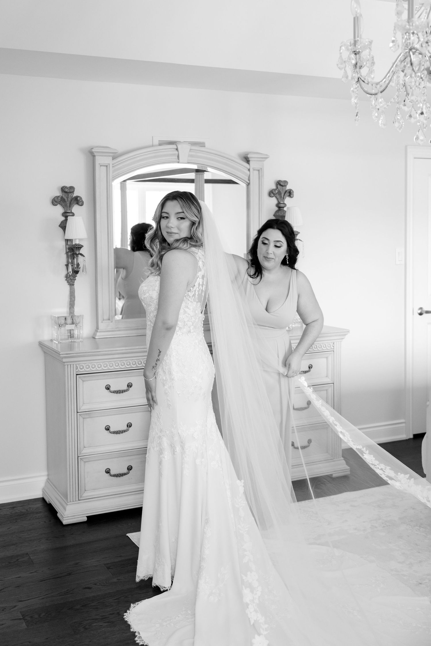 Black and white portrait of wedding preparation by elegant vintage dresser.
