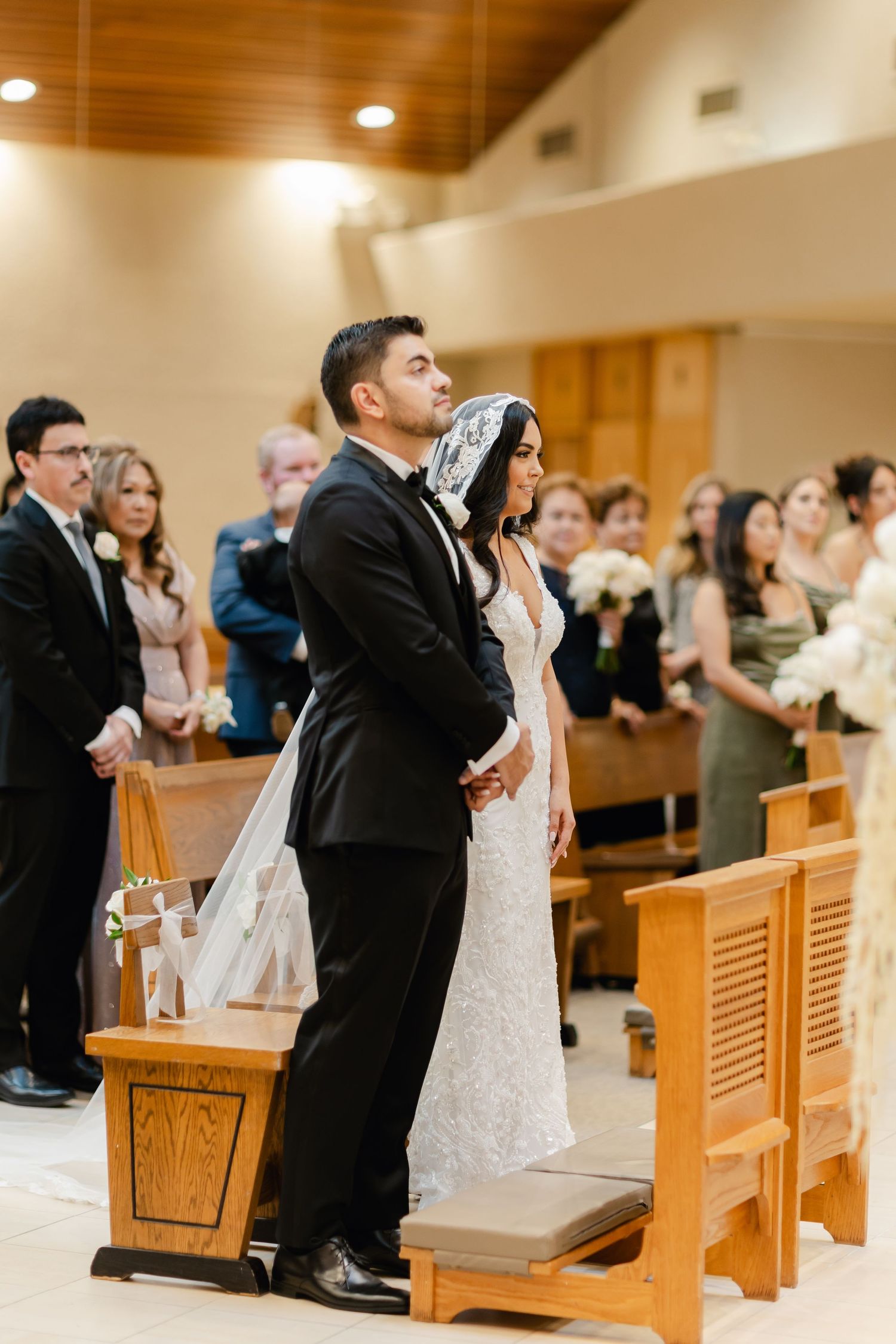 Wedding ceremony in a modern church with wooden pews and organ pipes.