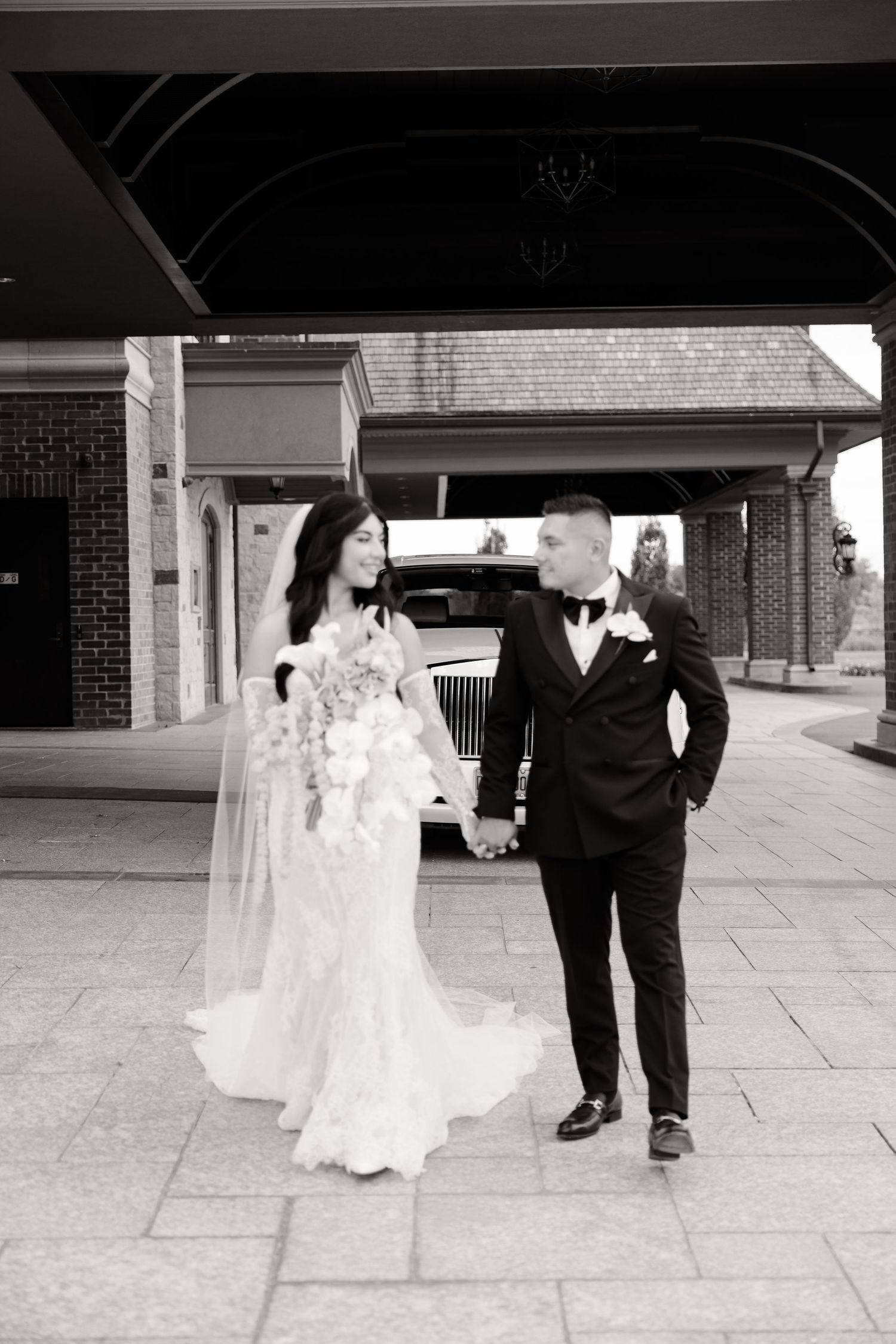 A bride in a white dress dances playfully with a suited figure at a wedding venue in a black and white photo sequence.