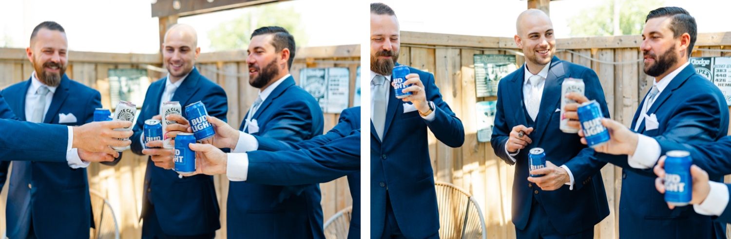 Groomsmen in matching navy suits share drinks and laughs during pre-wedding preparations.