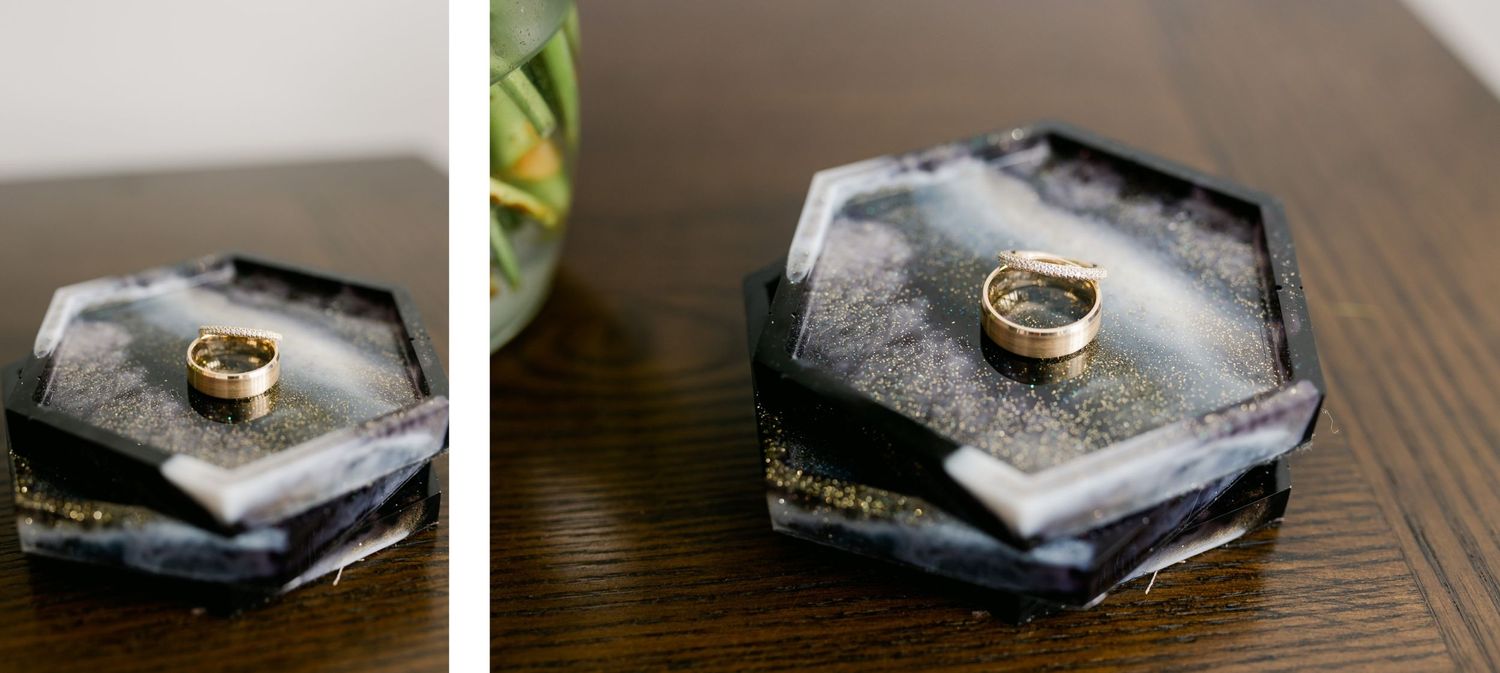 Wedding rings displayed on modern hexagonal gray ring holders.