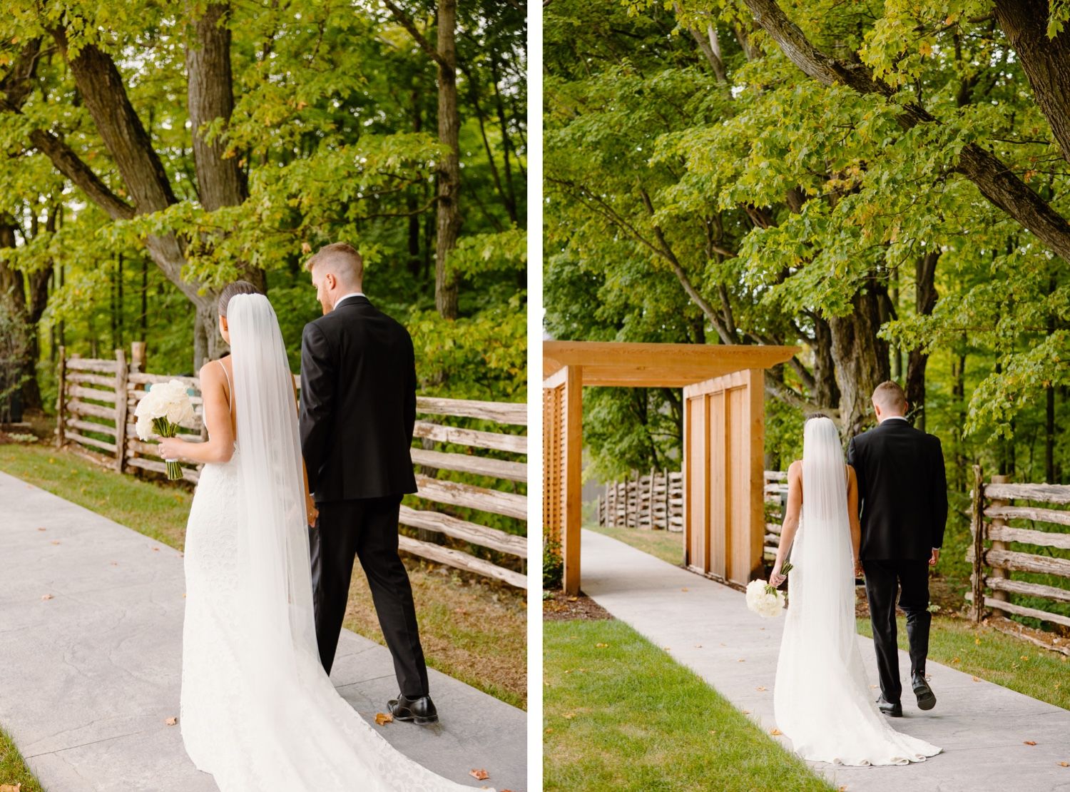 Wedding couple walks along pathway with wooden fence and archway in natural outdoor setting.