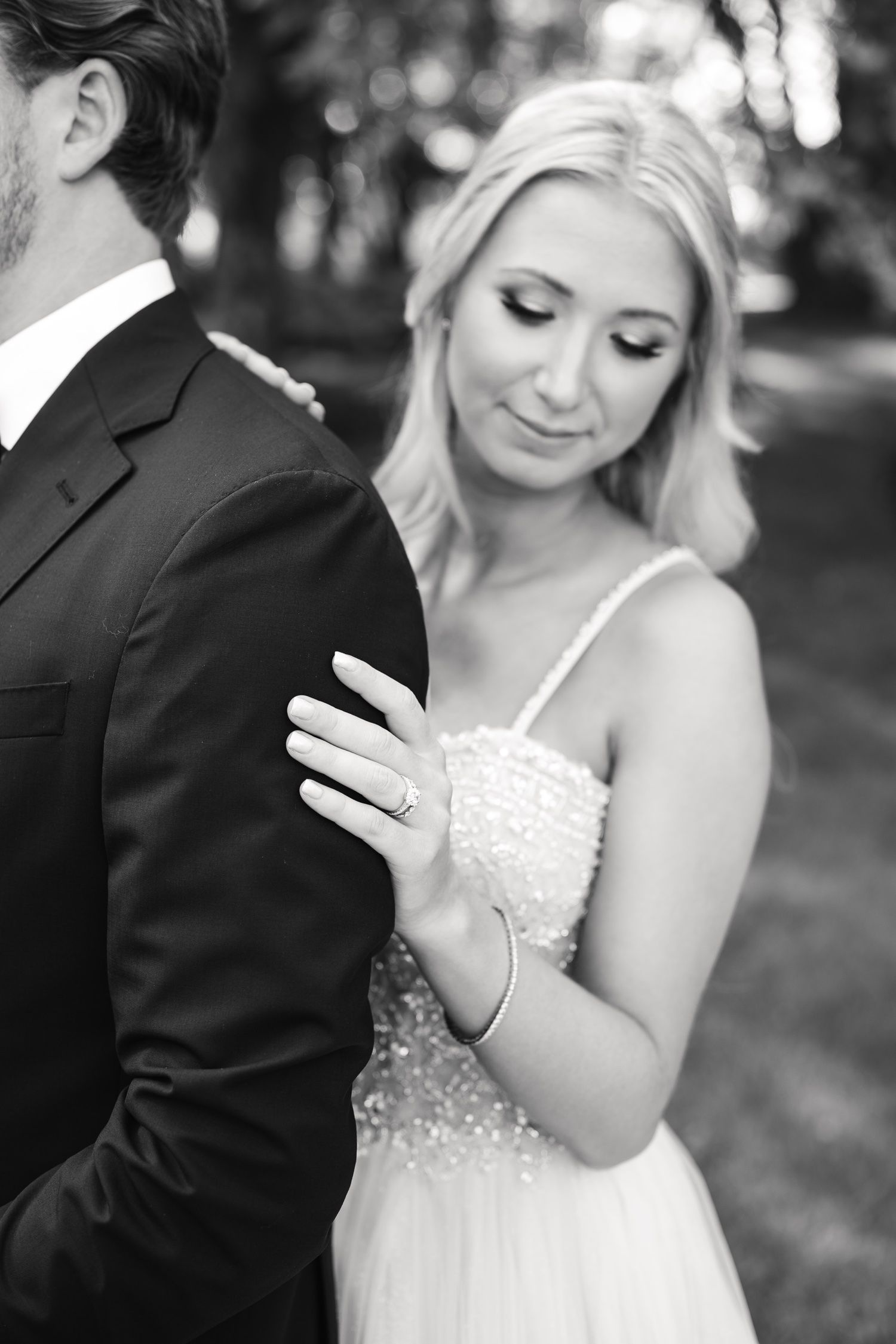 Black and white intimate wedding portrait showing close up of couple in formal attire.