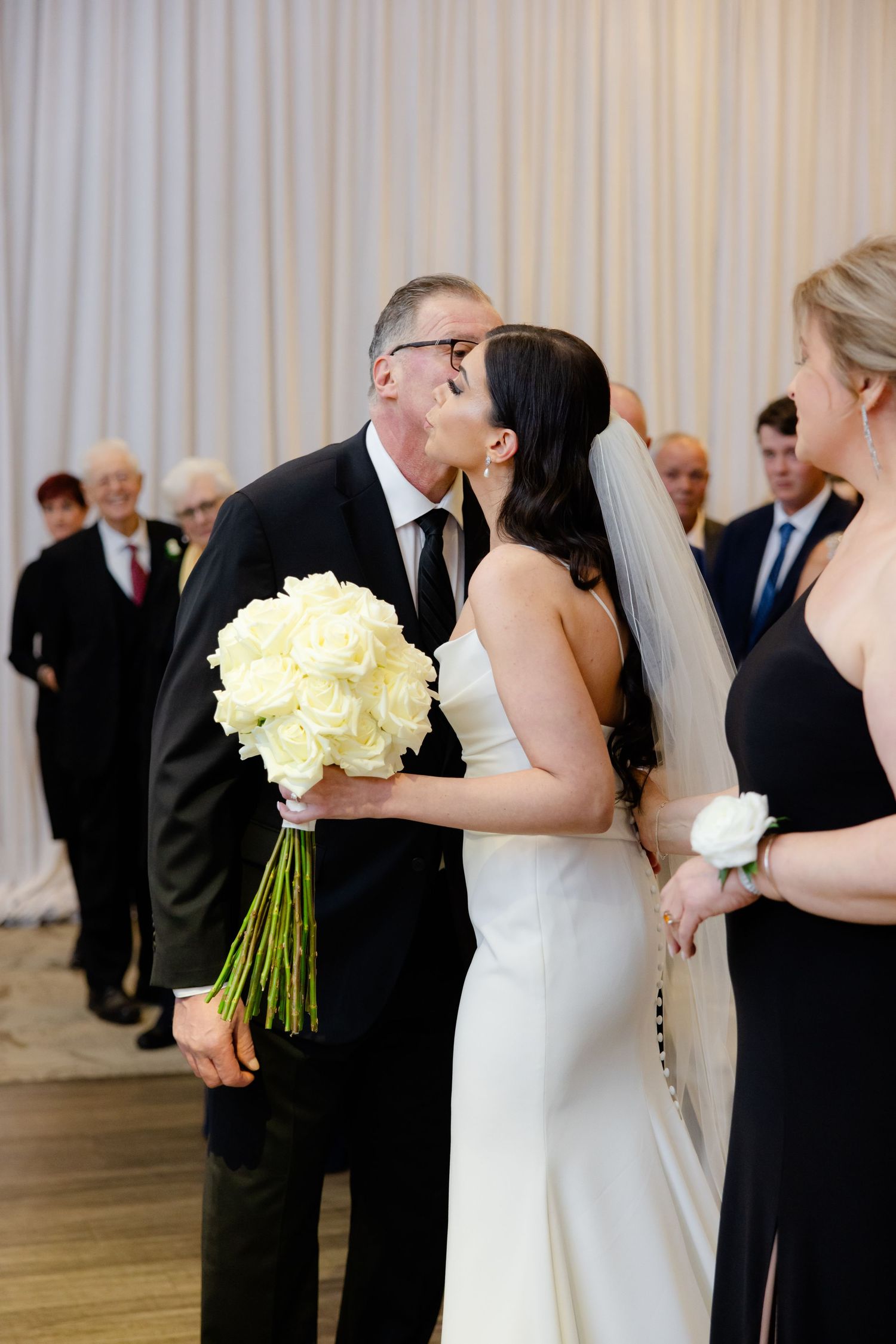 Tender moment captured between wedding party members during the ceremony.