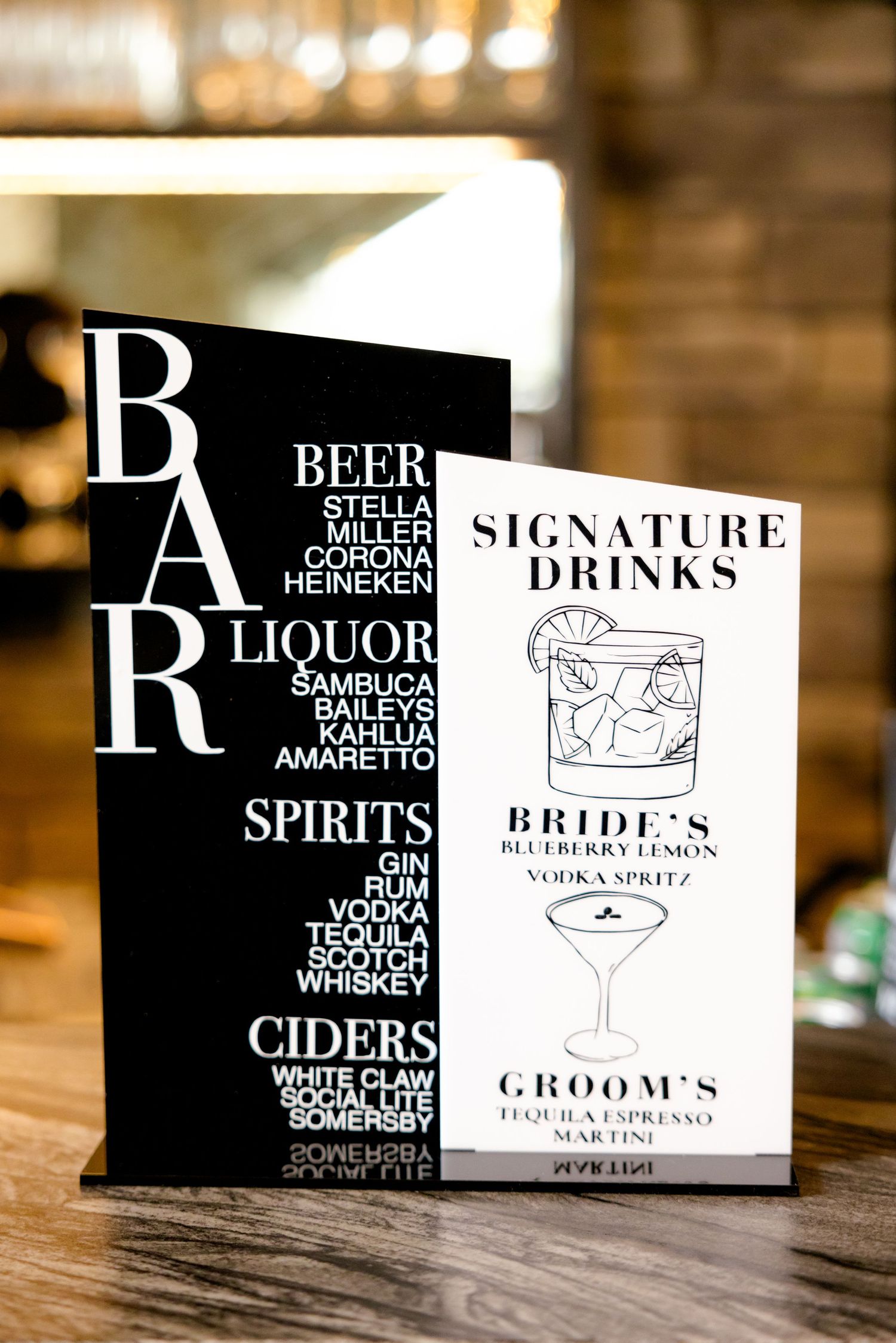 Bar menu displaying signature drinks and beverage options on black cards.