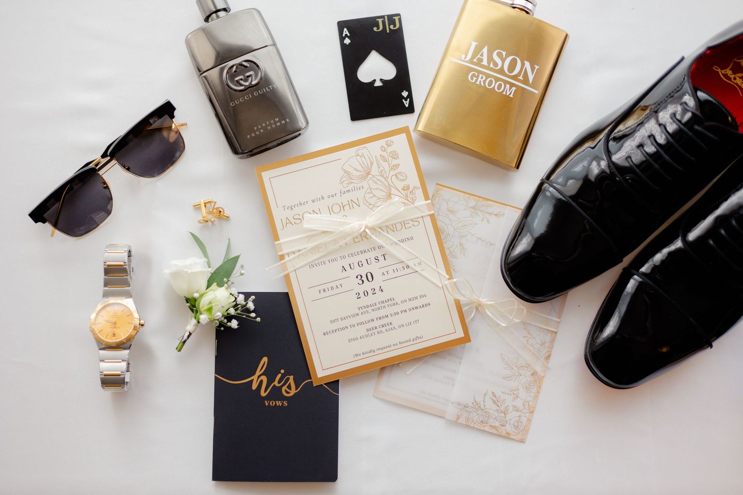Wedding accessories flat lay with sunglasses, perfume, invitation, watch and dress shoes.