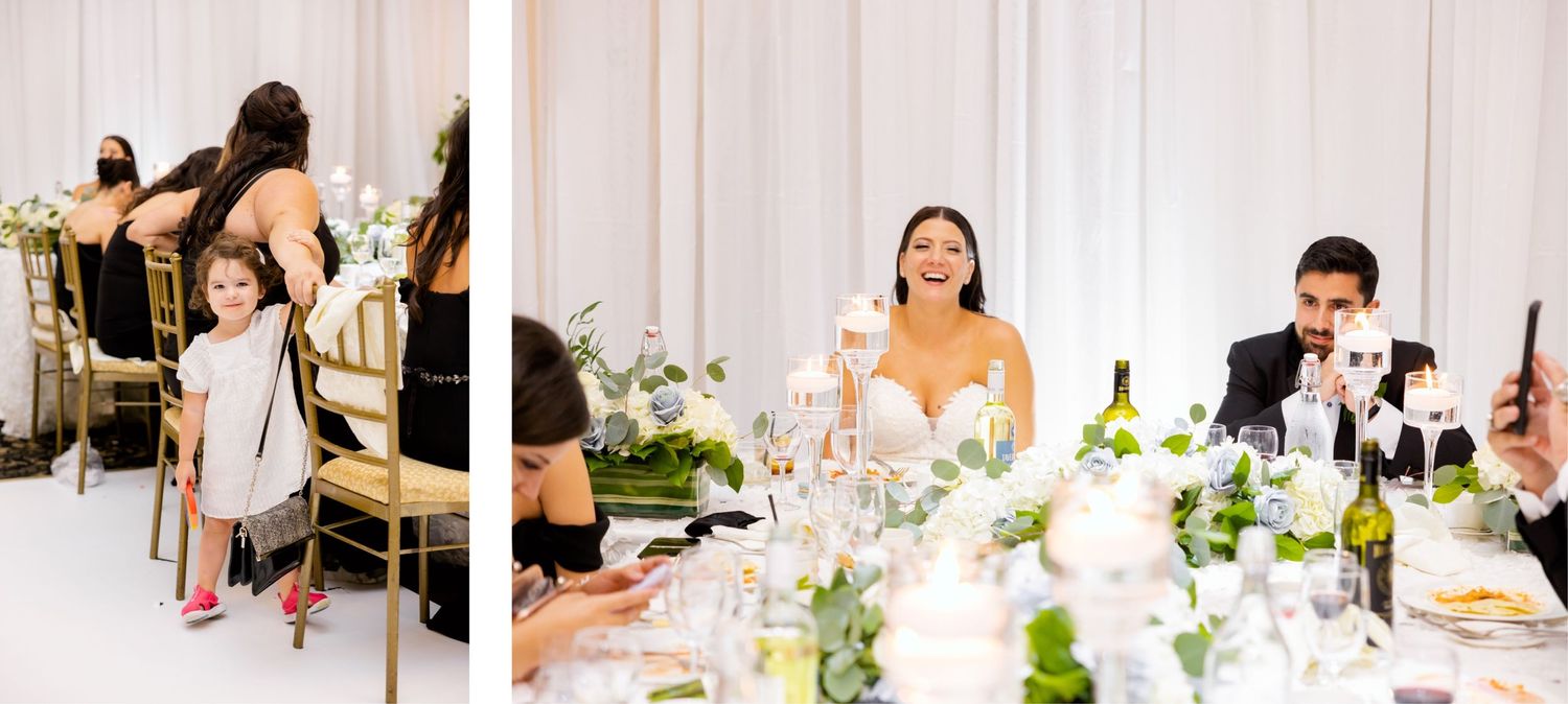 Wedding reception candids showing joyful moments at the dinner table with elegant floral decorations.