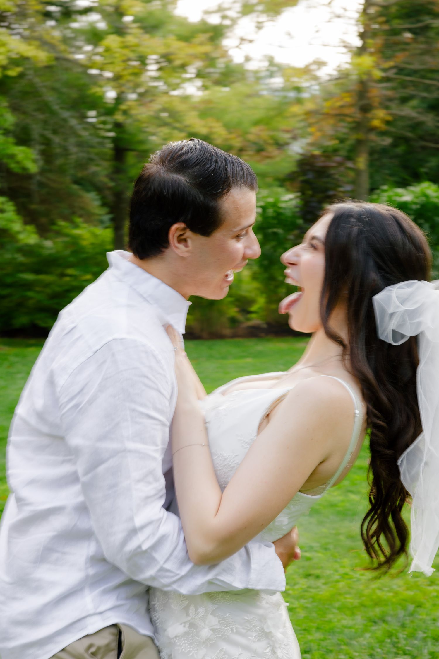 A joyful candid moment between a couple laughing together during their outdoor photo session.