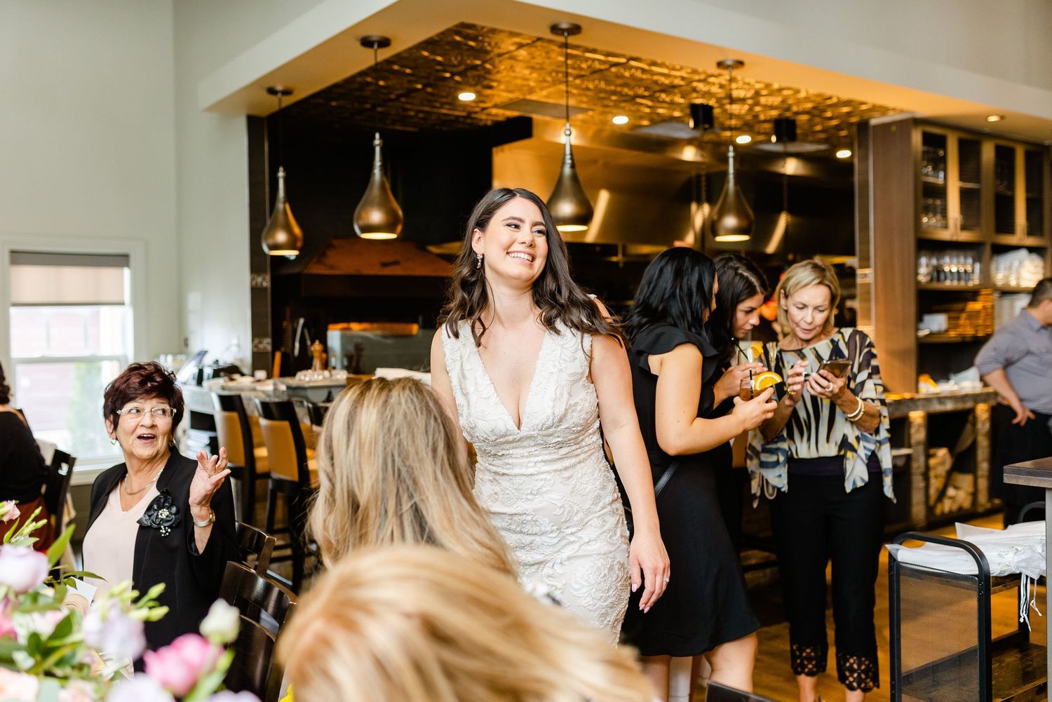 A celebration event in a restaurant venue with pendant lighting and elegant decor.