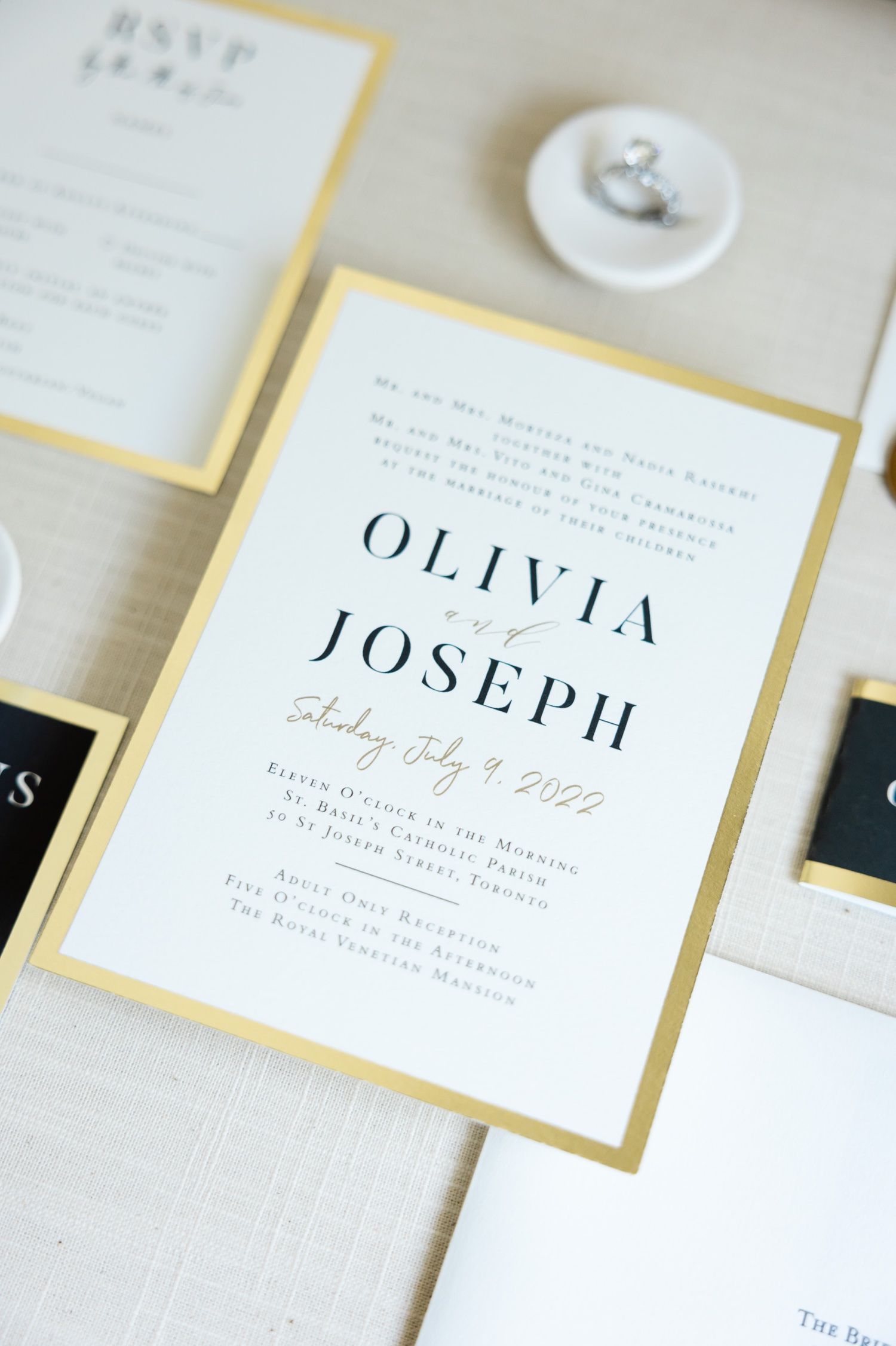 Classic wedding invitation with gold border displaying Olivia and Joseph's names and details.