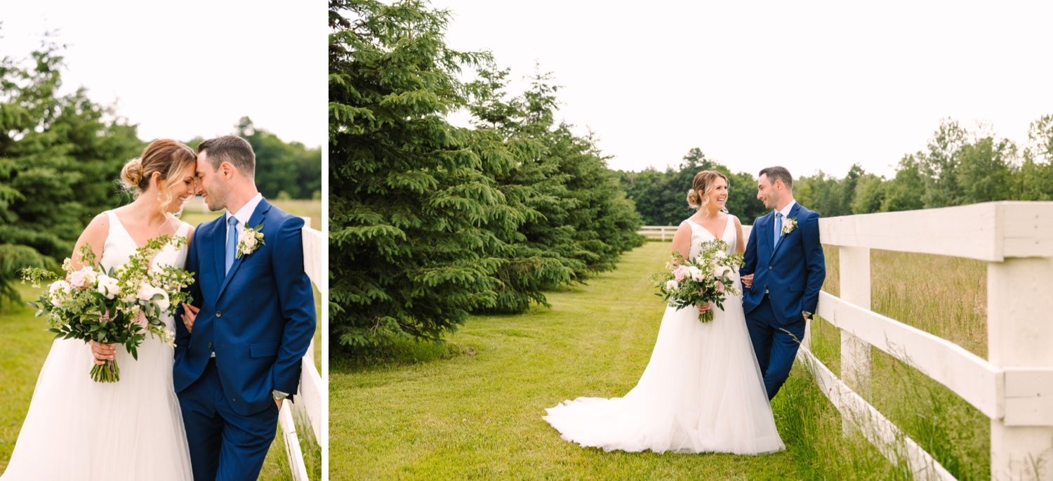 Romantic wedding portraits captured along a white fence with evergreen trees.