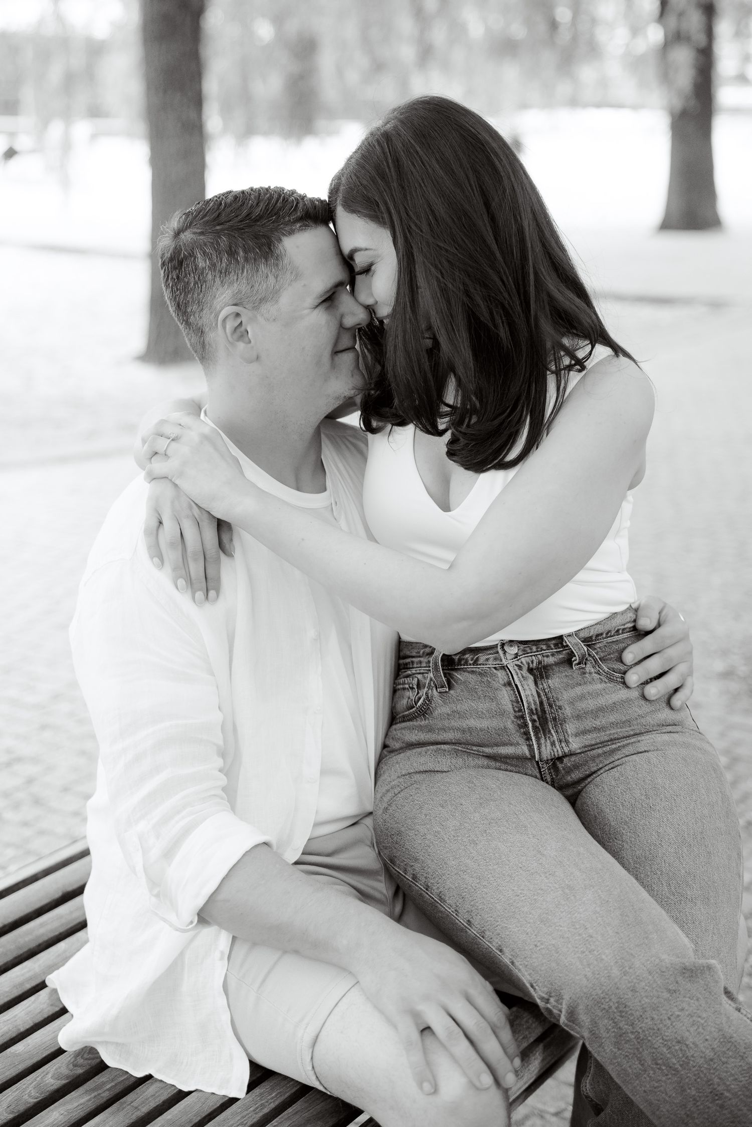 A romantic black and white portrait showing an intimate moment between a couple.