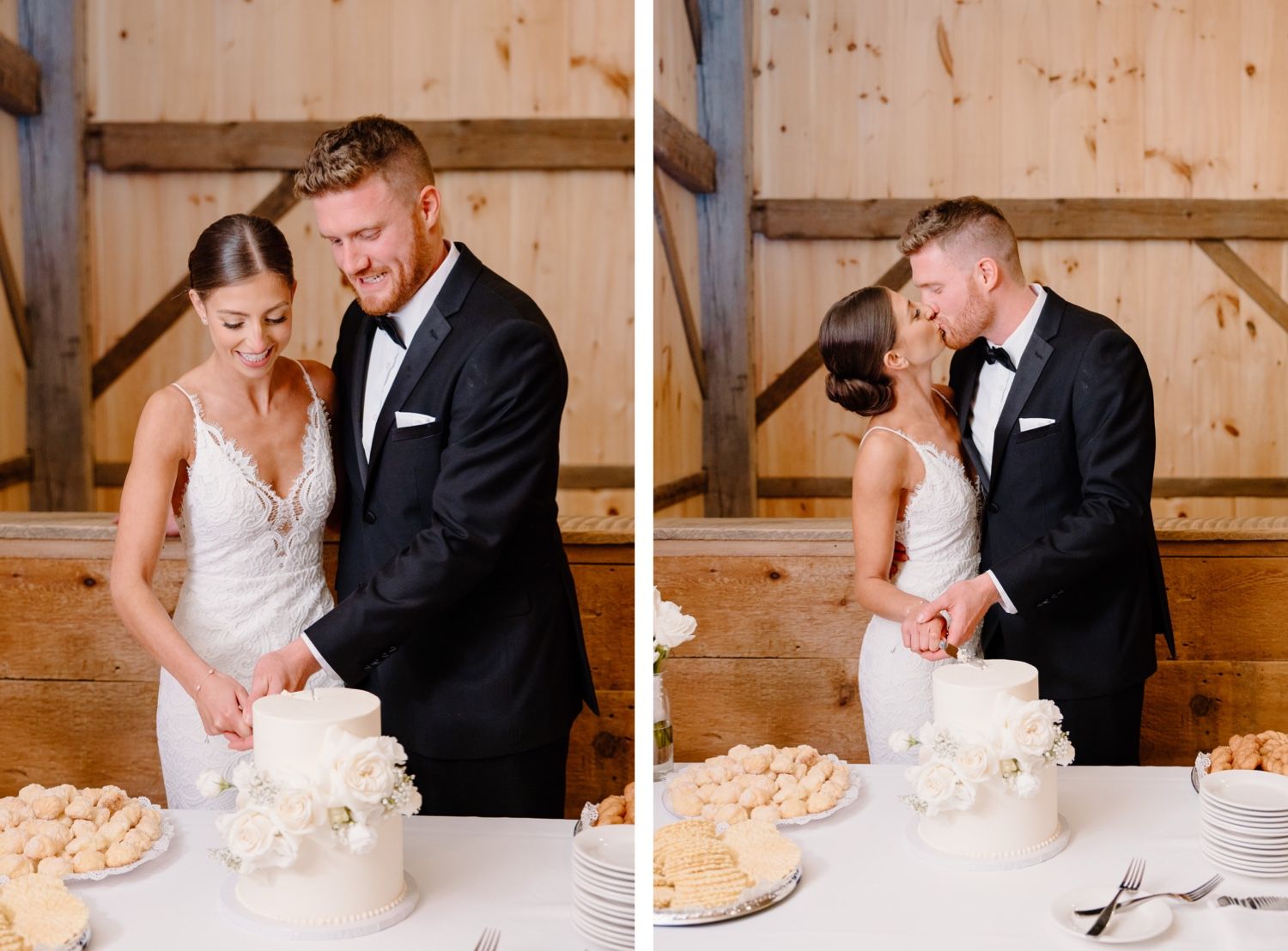 Newlyweds cutting their elegant white wedding cake together in a rustic barn setting.