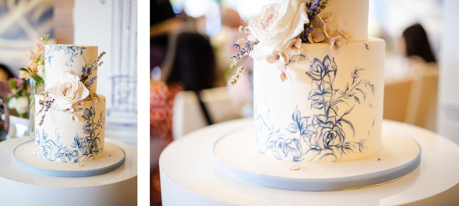 Elegant wedding cake with delicate blue hand-painted floral designs and gold accents.