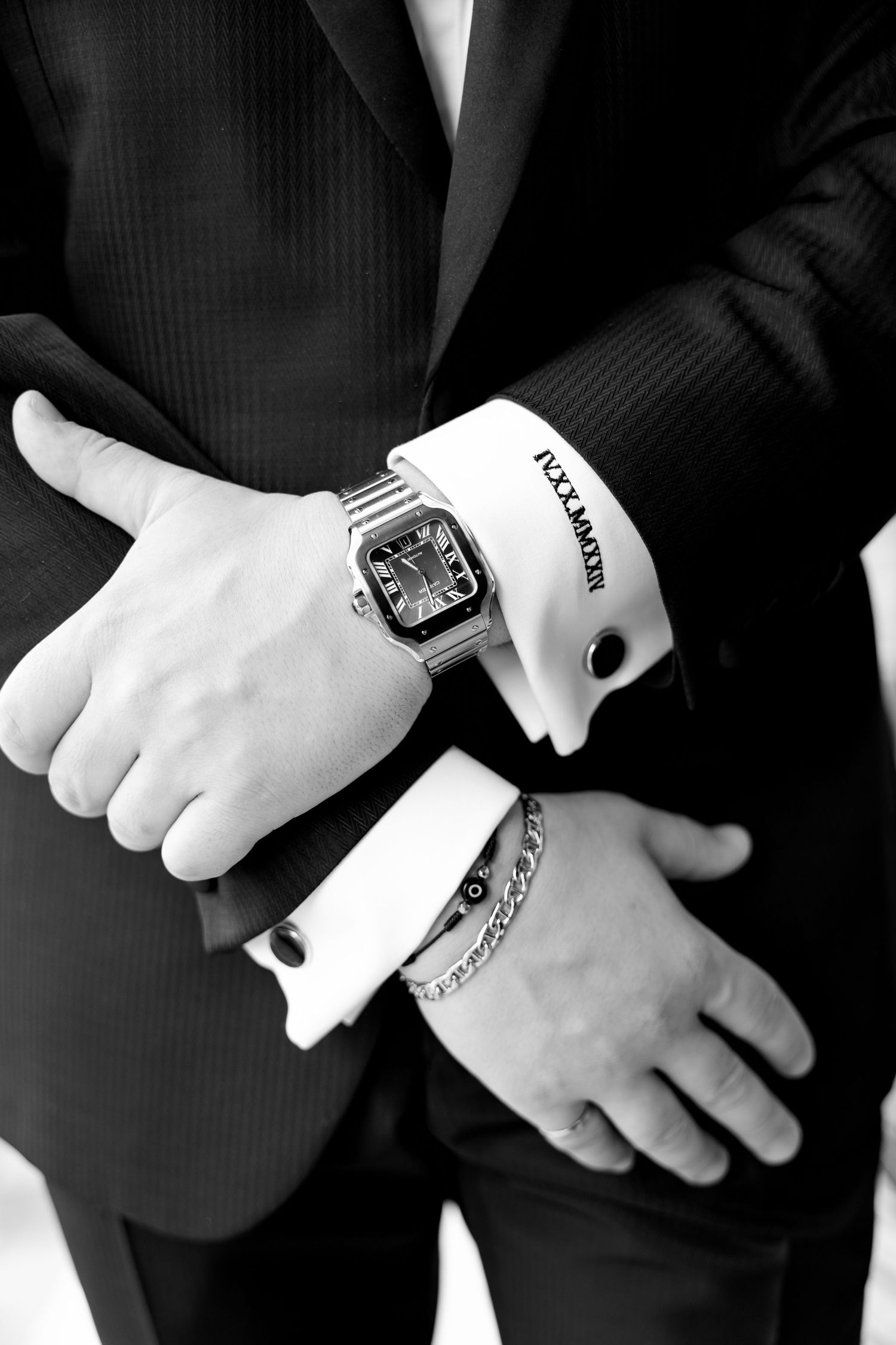 Close-up of formal suit sleeve with luxury watch and cufflinks.