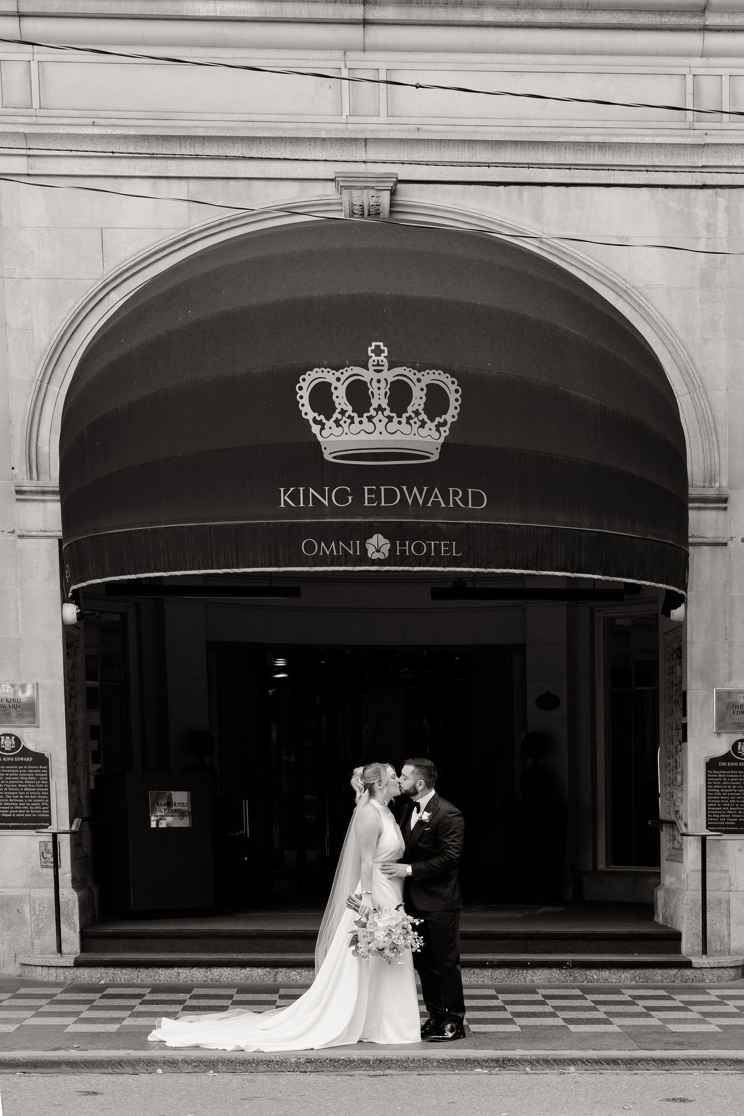 Black and white wedding portraits taken at the elegant King Edward Hotel entrance.