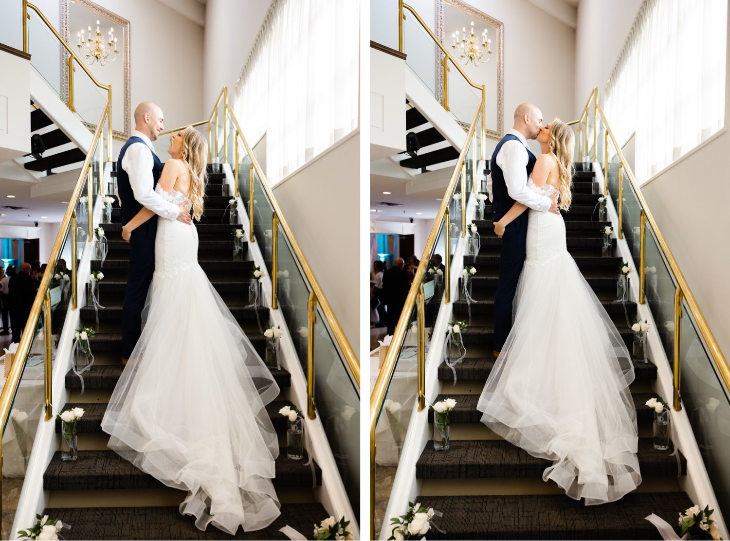 Wedding couple posing on an elegant staircase decorated with white floral arrangements.