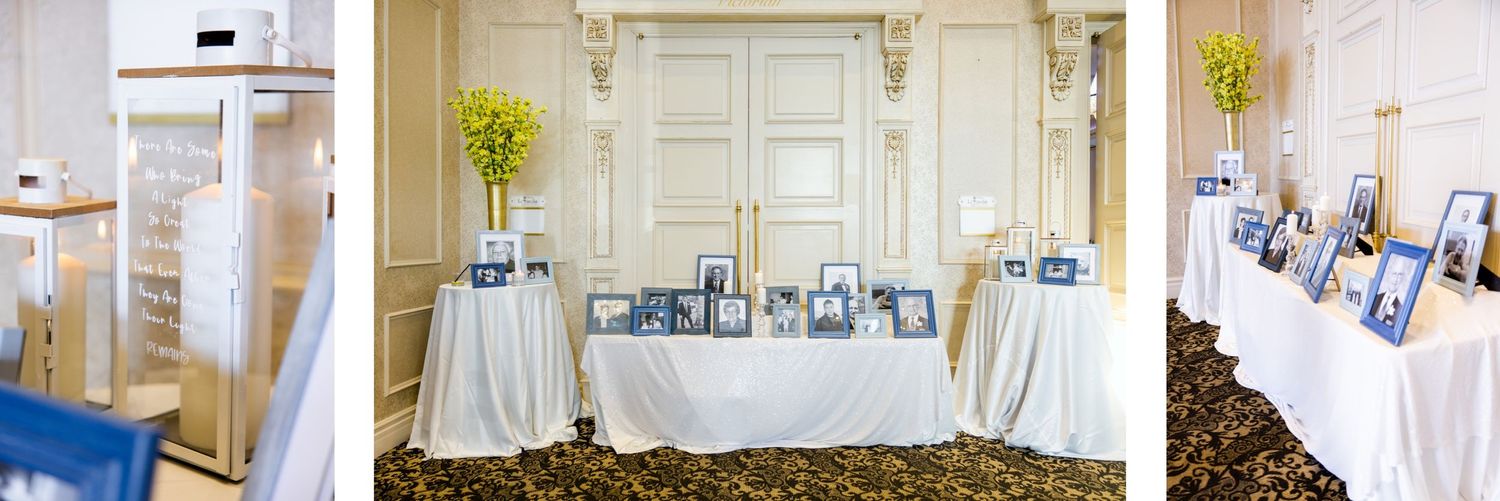 Wedding reception memory table display with white decor and framed photos.