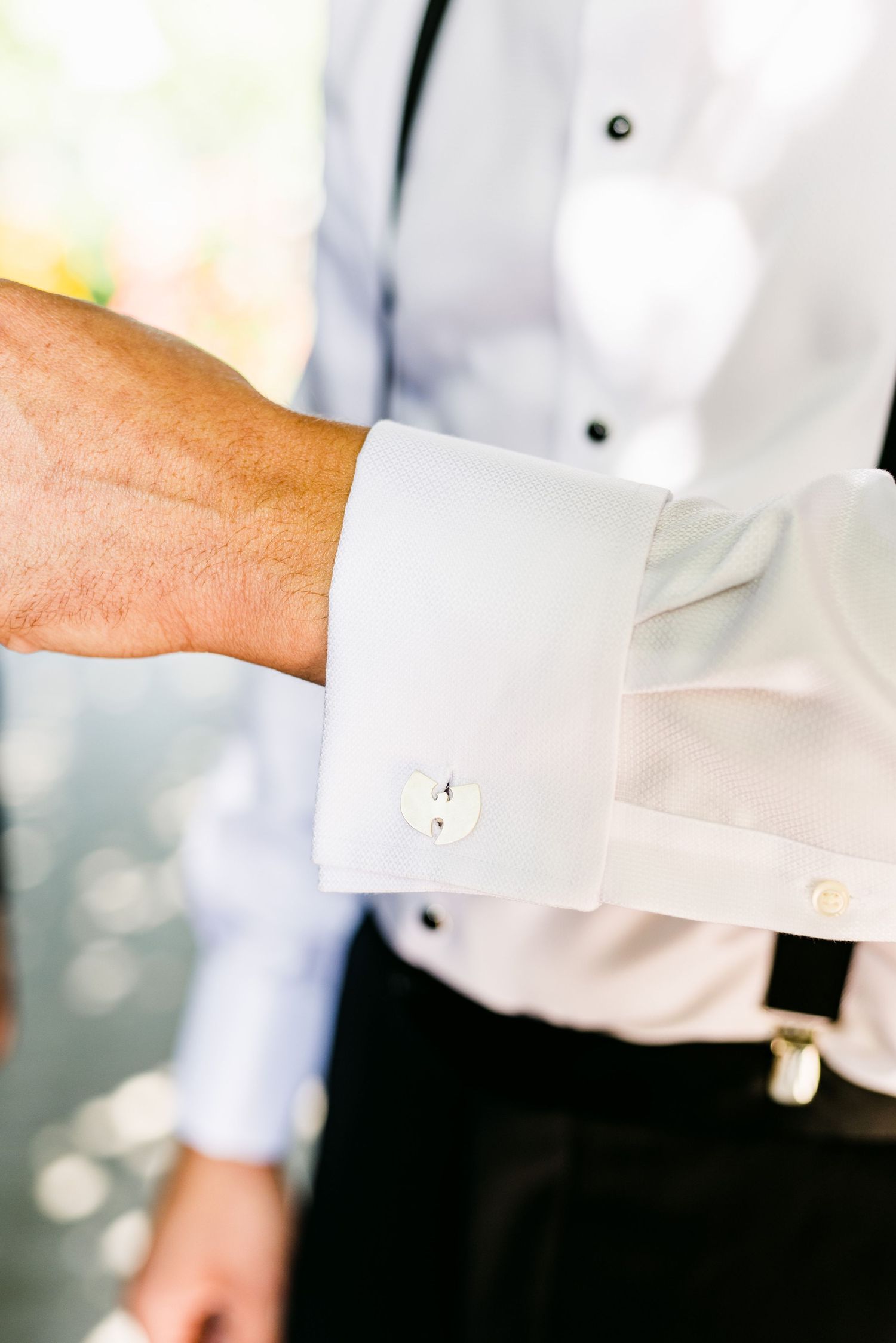 Close-up of a formal white dress shirt cuff with cufflink detail.
