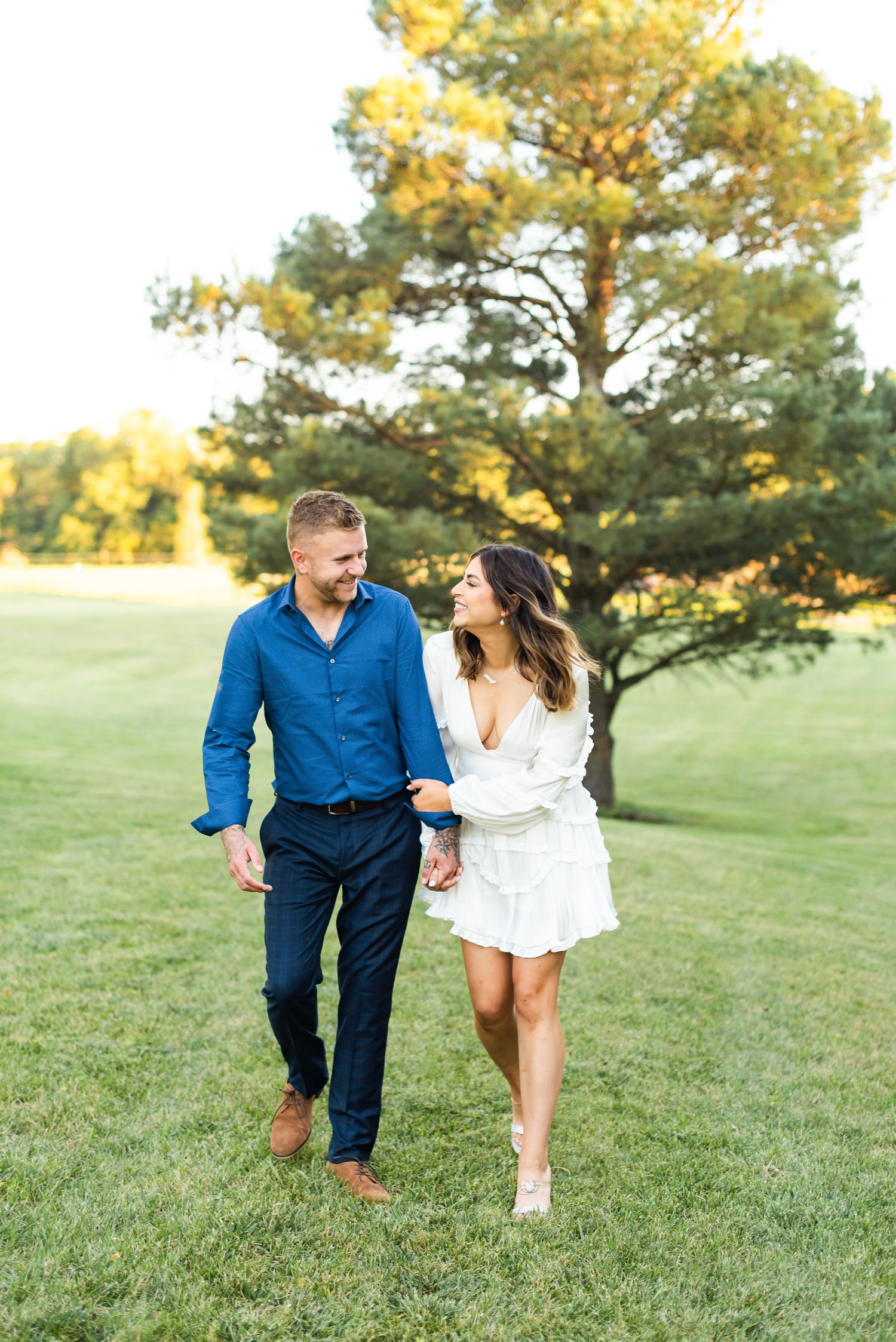 Joyful couple enjoying afternoon walk together in a serene park setting.