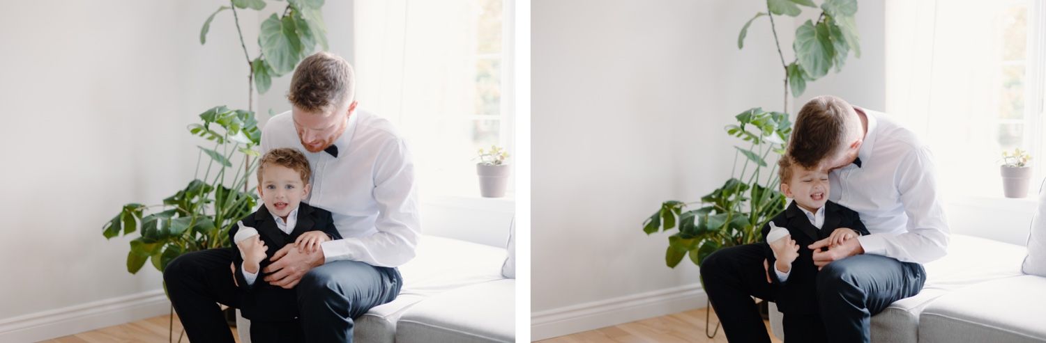Two people share a tender moment near a potted plant in a bright white room.