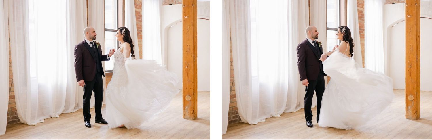 A pair dancing and twirling in a light-filled room with wooden pillars.