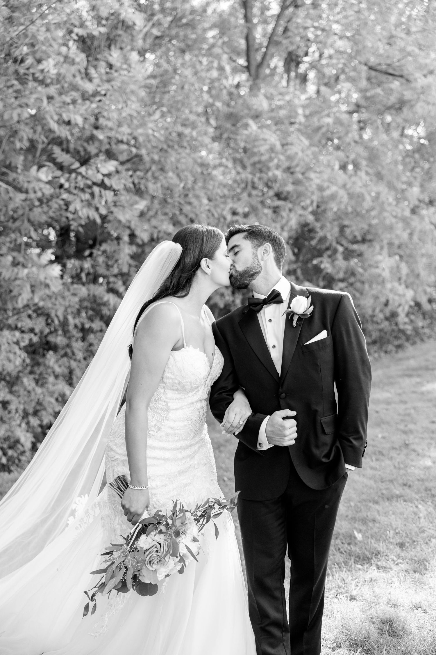 Black and white romantic wedding portrait captures intimate moment between couple.