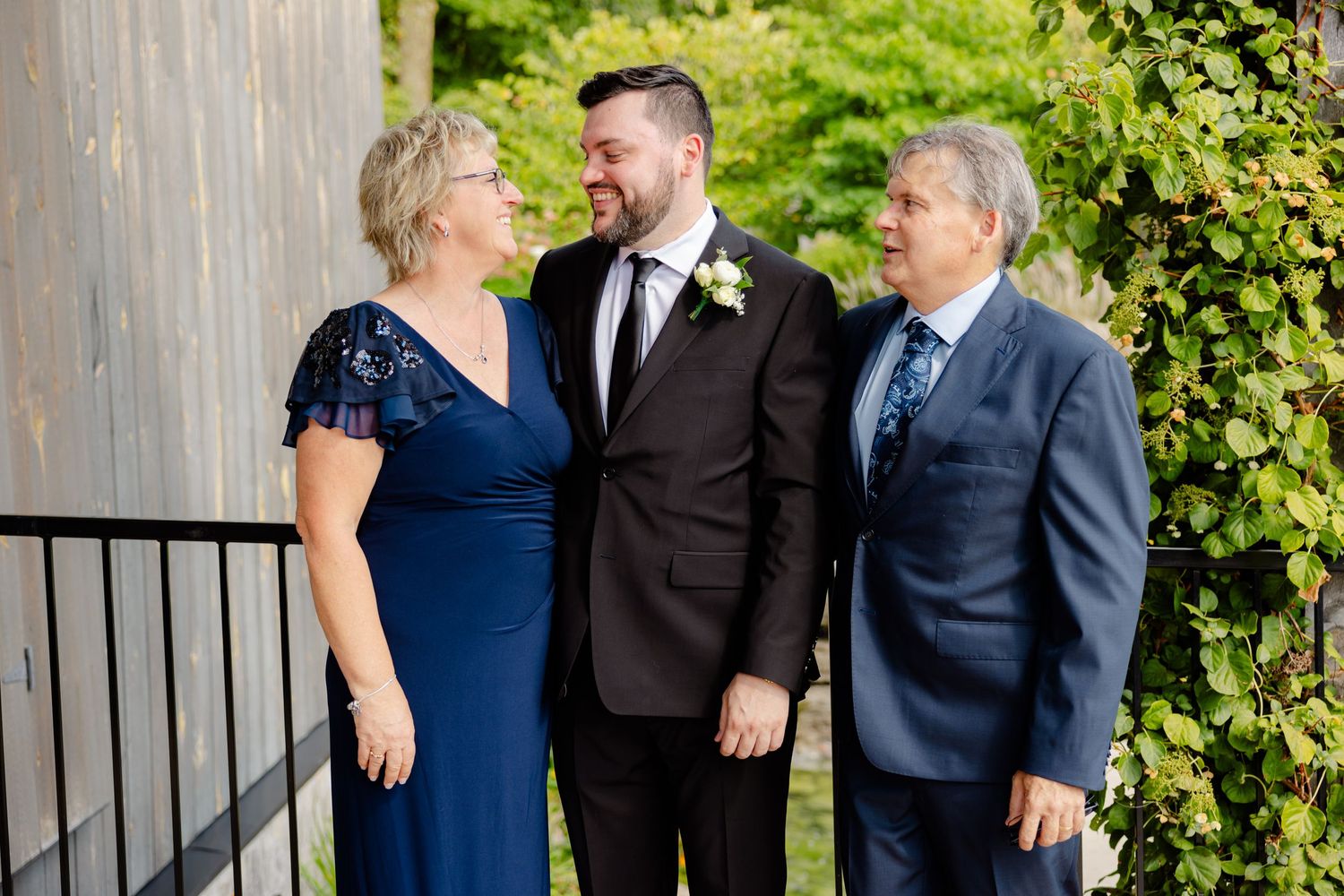Family shares joyful moment on outdoor deck during special occasion.