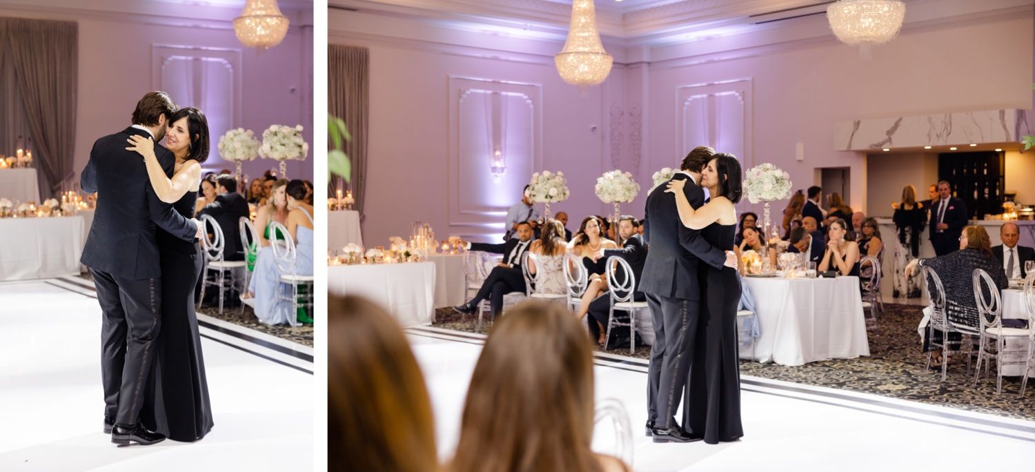 Couple dancing in ballroom surrounded by elegant wedding reception decor and guests.