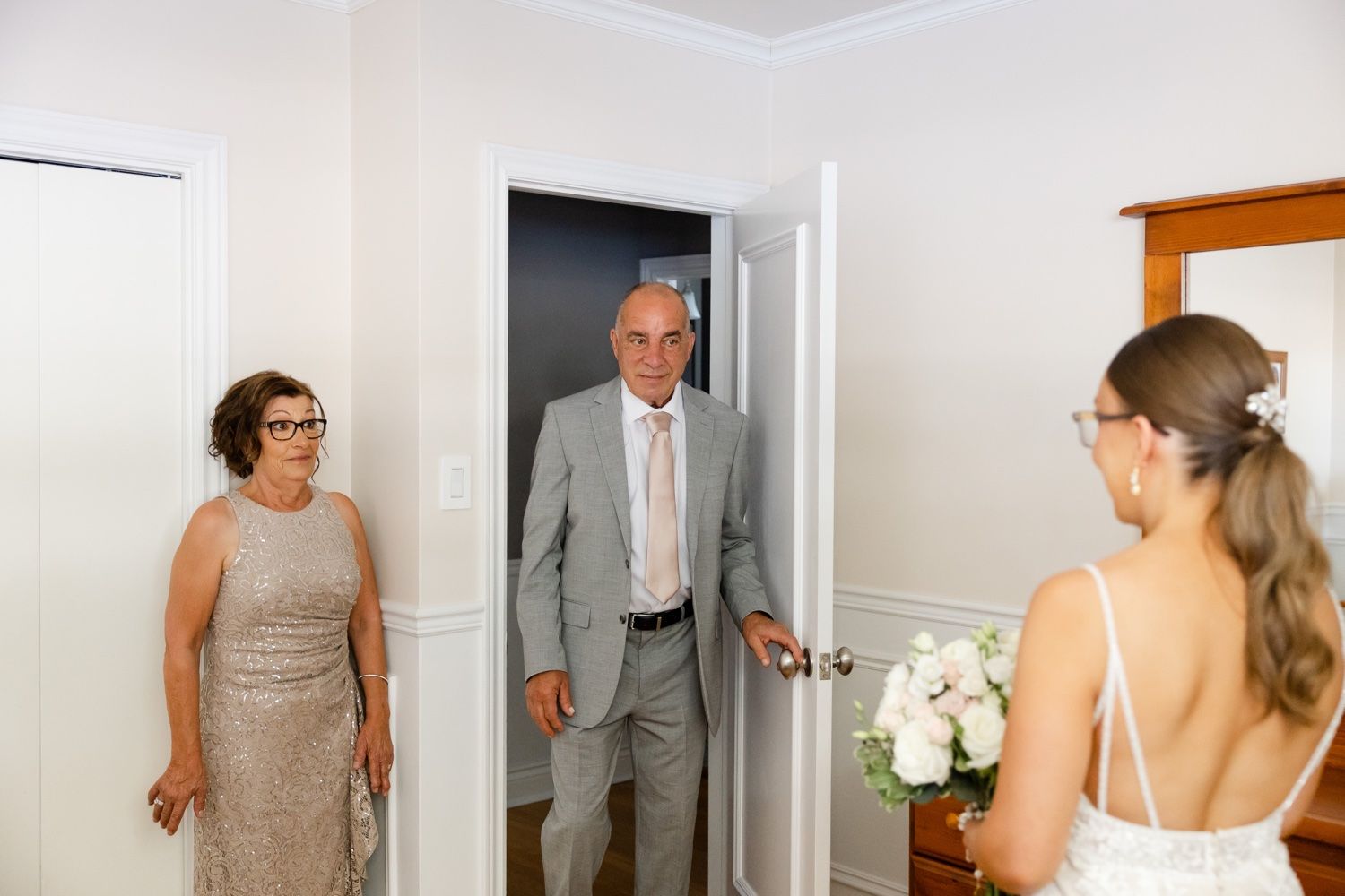 Candid moment during wedding preparations in a bright indoor setting.