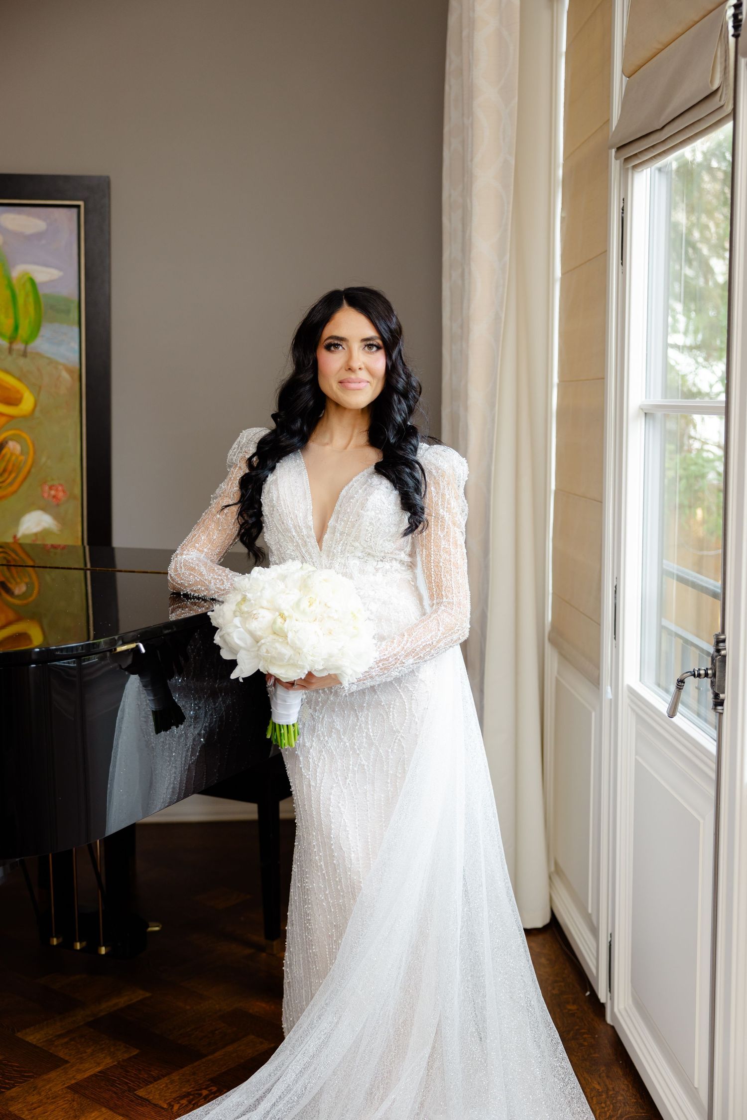 Classic bridal portrait featuring long sleeve lace gown and white peony bouquet.