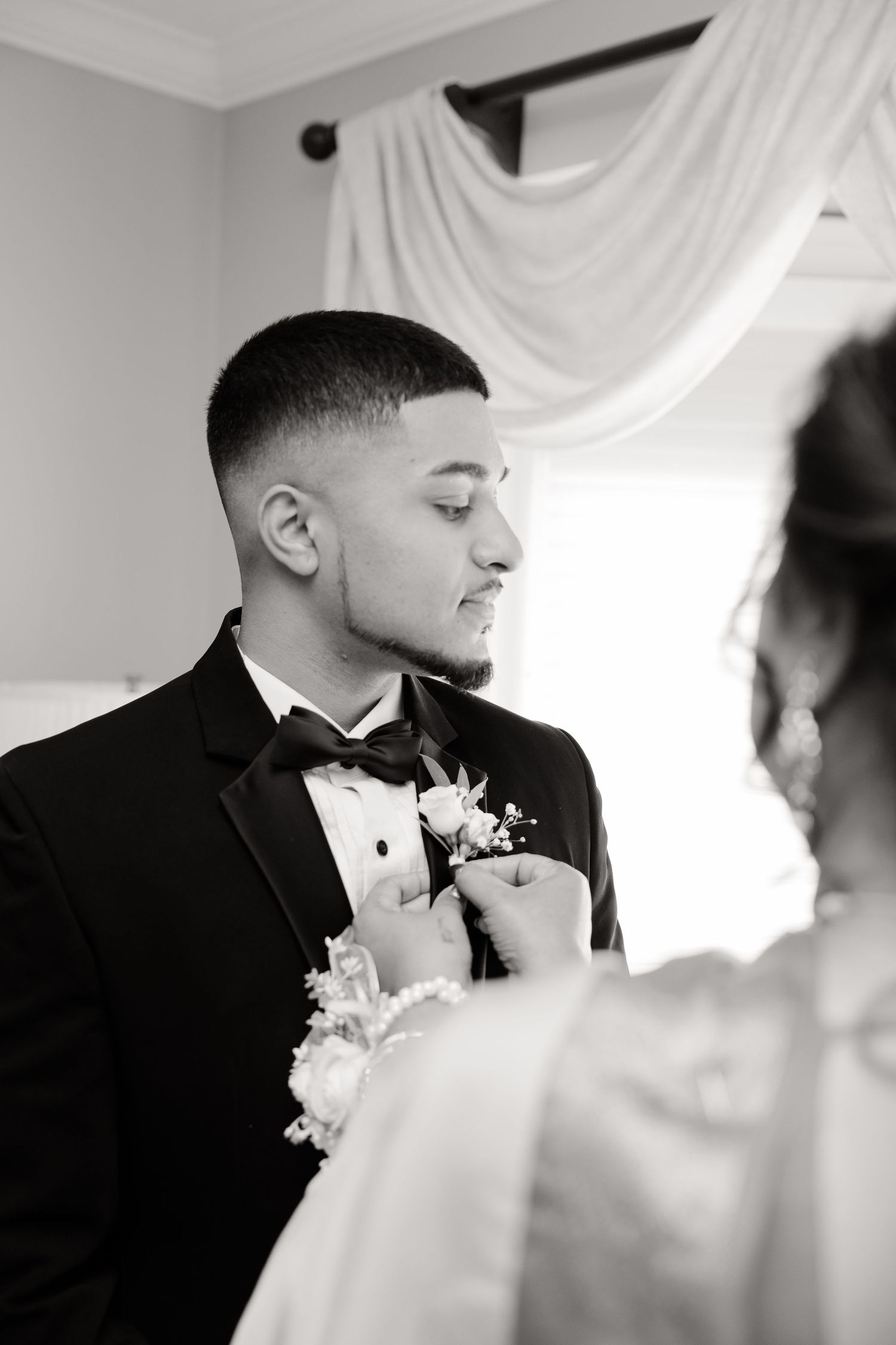 Black and white intimate wedding moment with couple during ceremony.