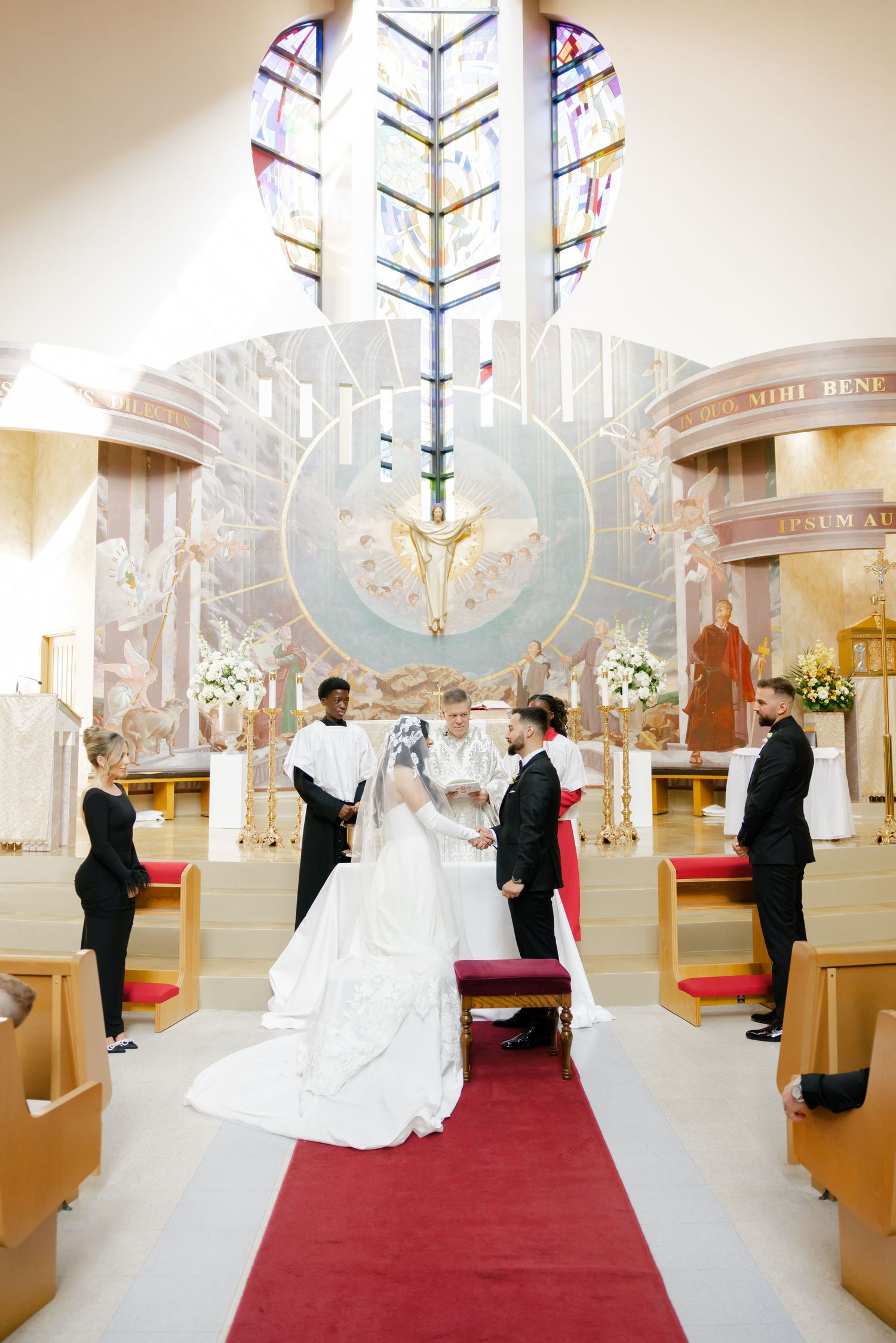 Beautiful church altar with stained glass dove design during wedding ceremony.