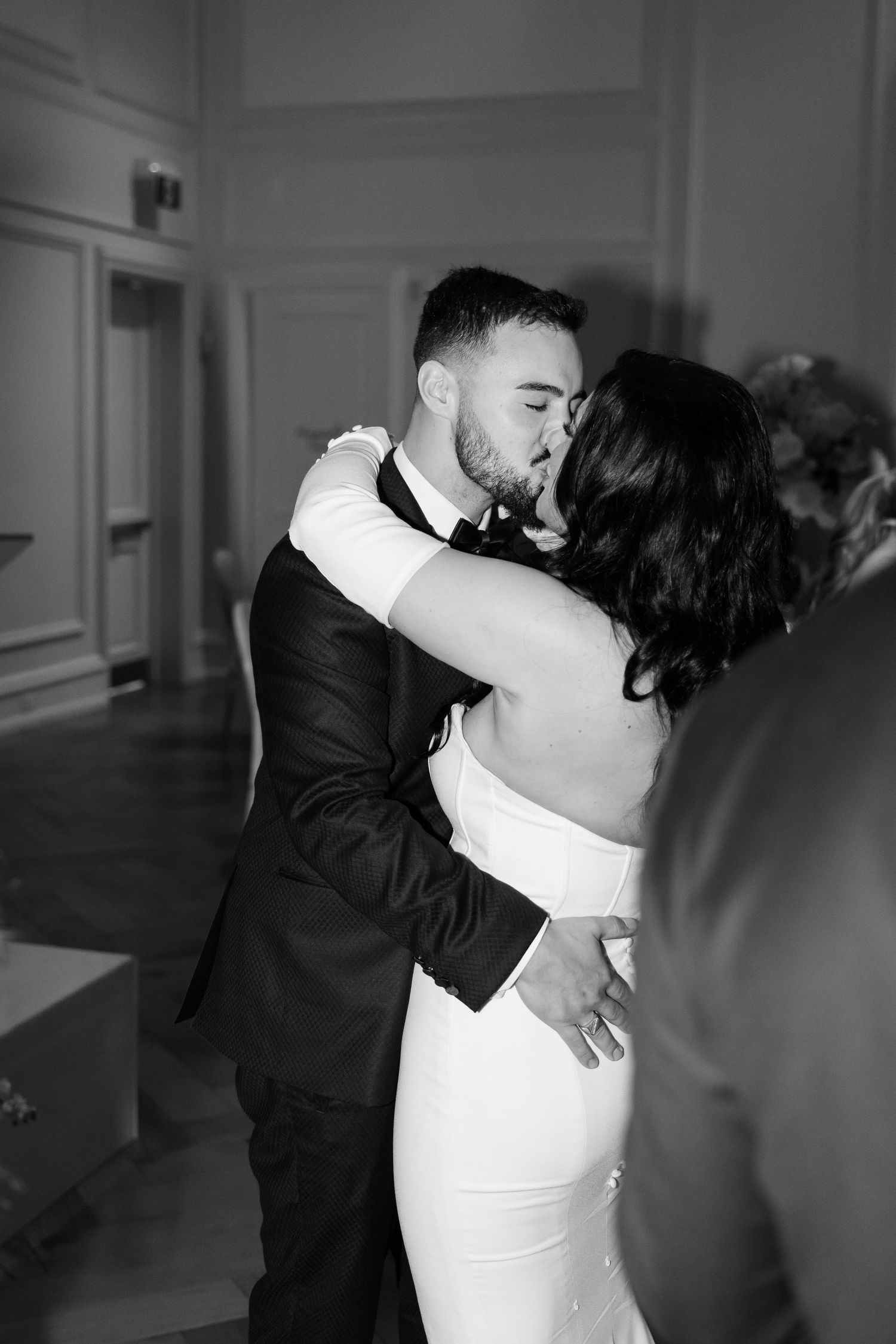 A romantic black and white dance moment captured at an elegant wedding reception.
