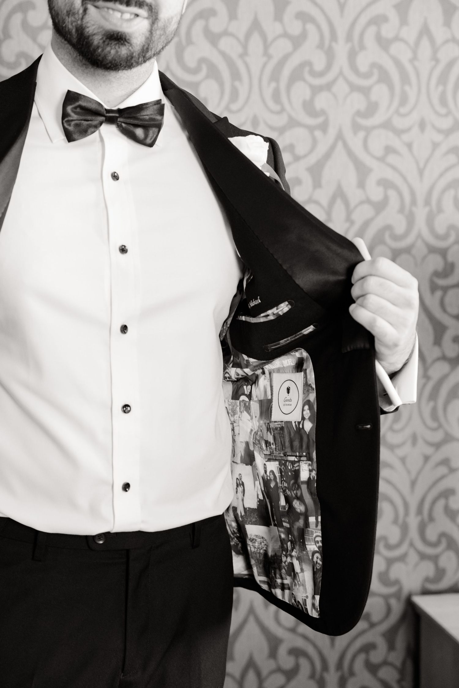 Black and white detail shot of custom photo lining inside tuxedo jacket.