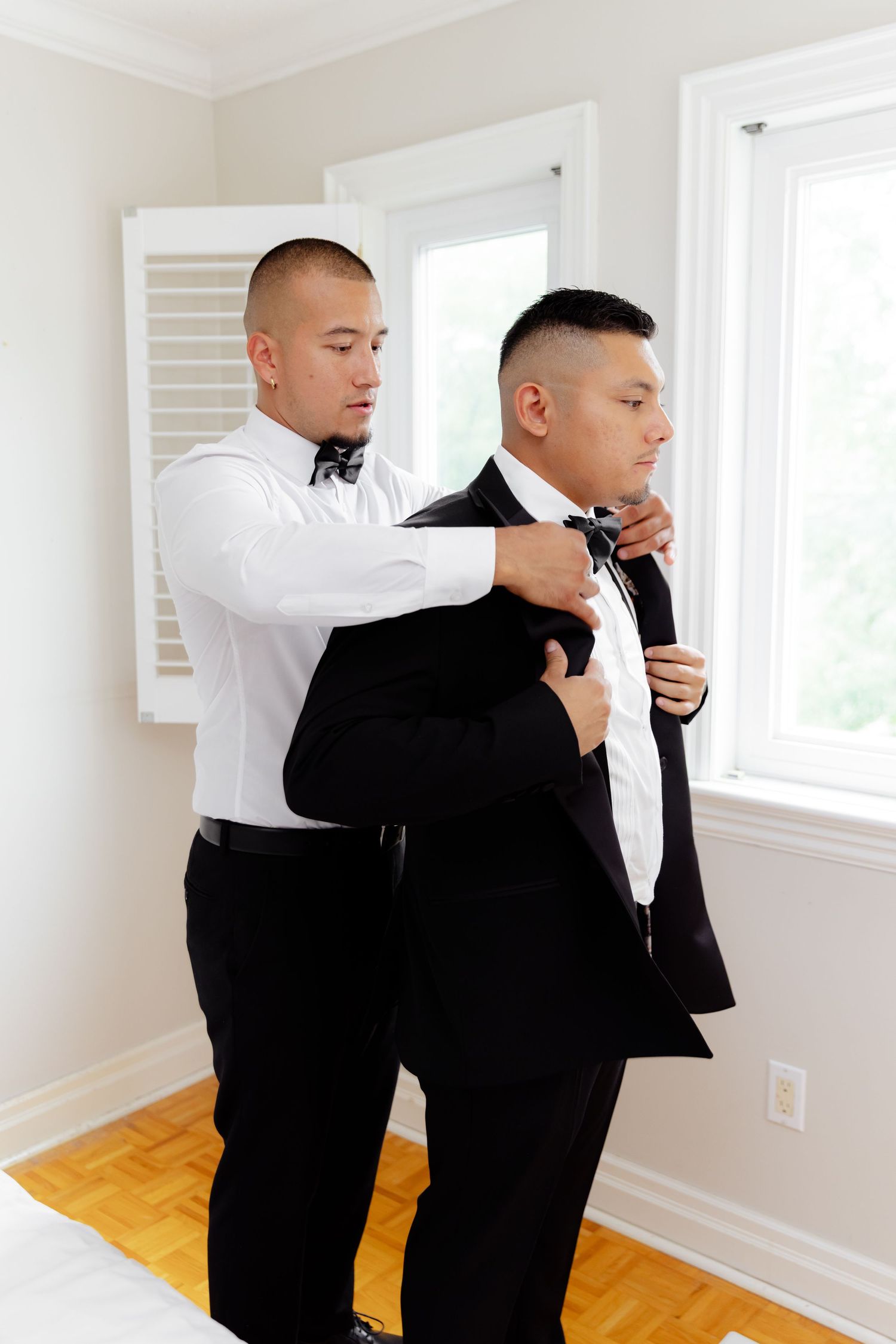 A sequence of photos shows the process of adjusting a black bow tie against a white formal shirt in an interior setting.