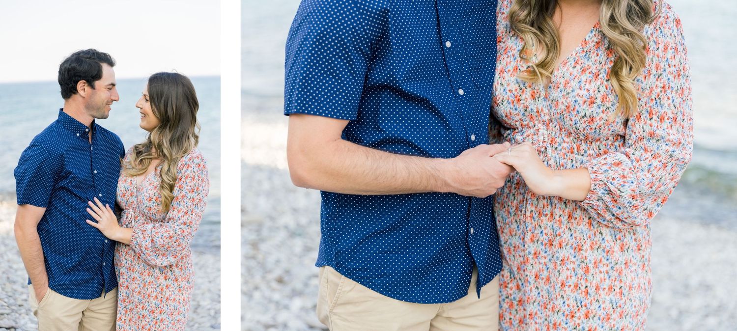 A couple in coordinated blue and floral outfits embraces at a seaside viewpoint.