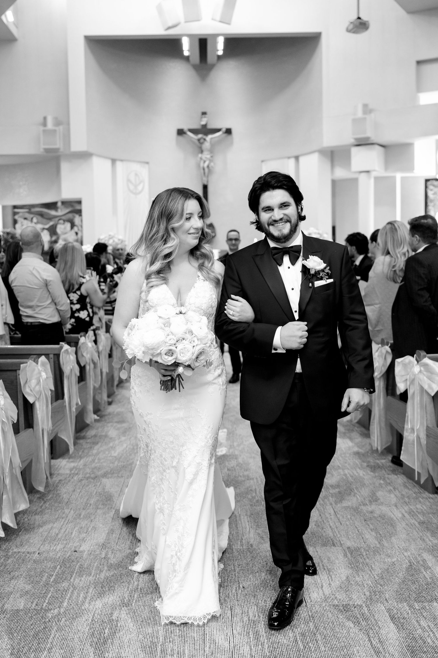 Elegant bride and groom walking down the church aisle after their wedding ceremony.