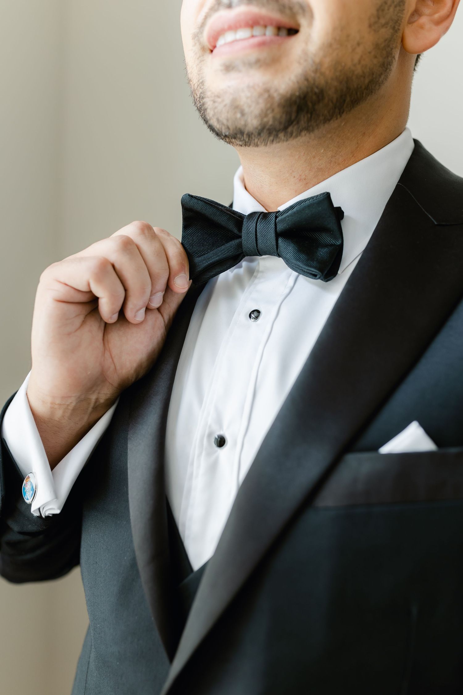 Close up of black bow tie and tuxedo lapel on formal attire.