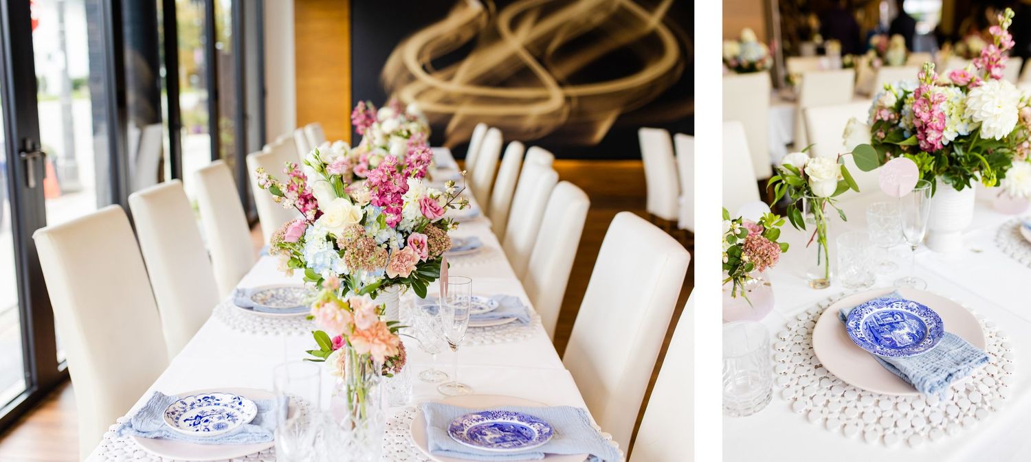 White dining tables adorned with pink floral arrangements and blue china place settings.