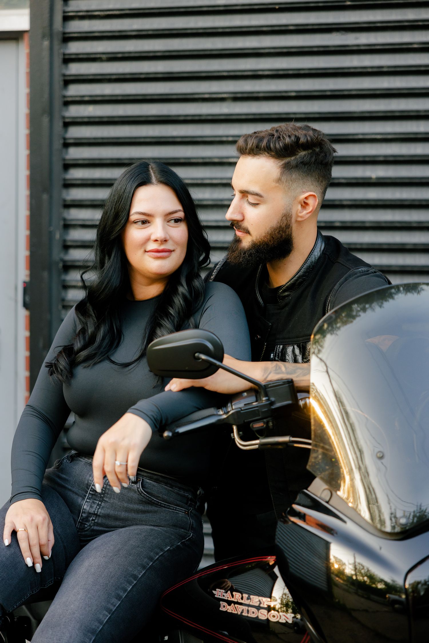 Intimate motorcycle portrait against corrugated metal background.