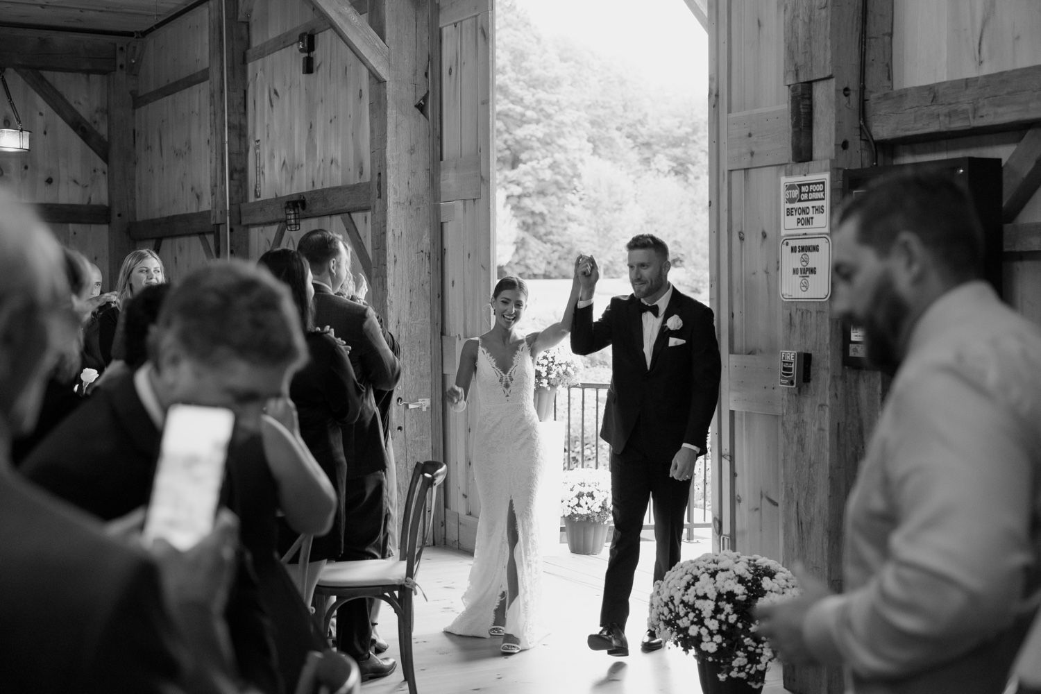 Wedding celebration entrance at rustic wooden barn venue.