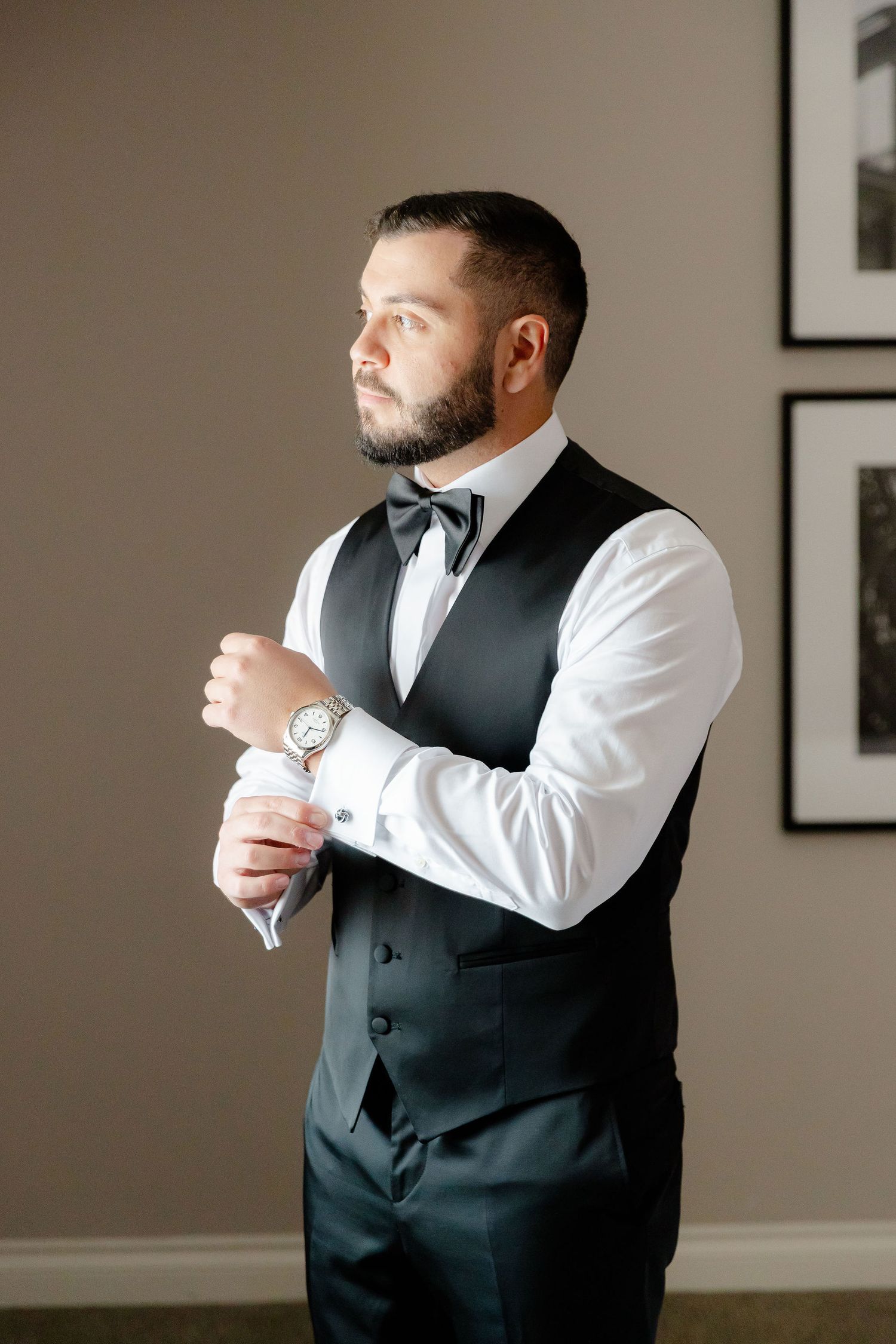 A series of shots showing someone adjusting cufflinks and a formal black vest.
