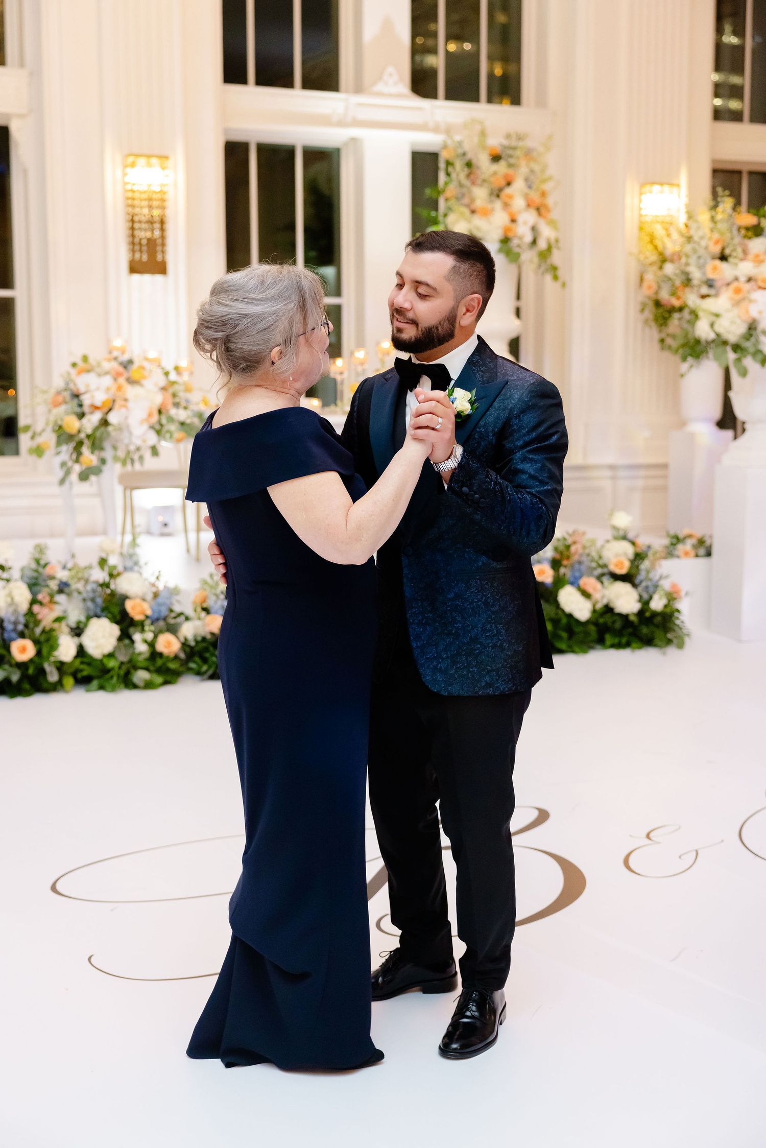 A series of photos showing a couple dancing in an elegant white ballroom with floral decorations.