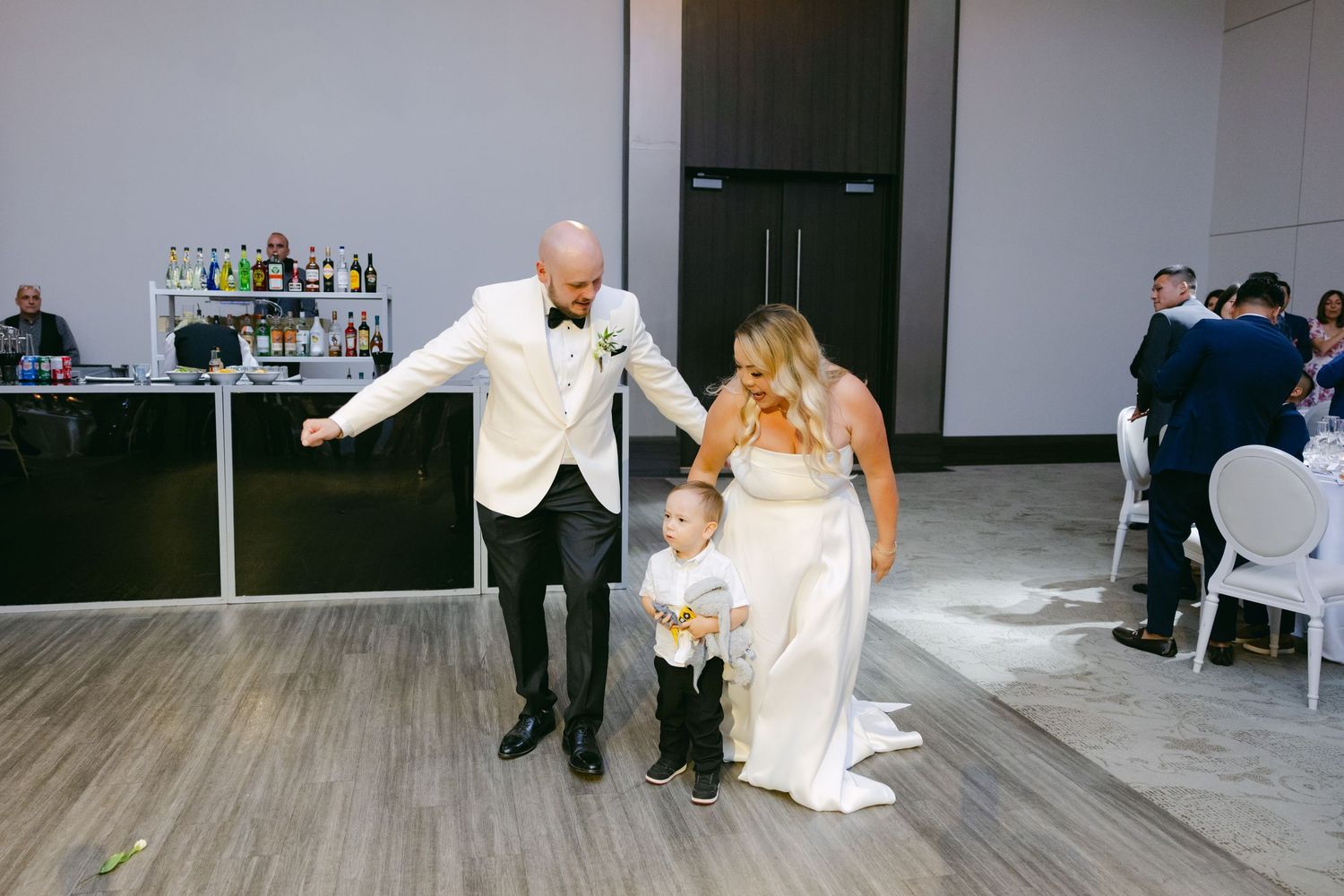 Wedding celebration scene with dancing in modern reception venue.
